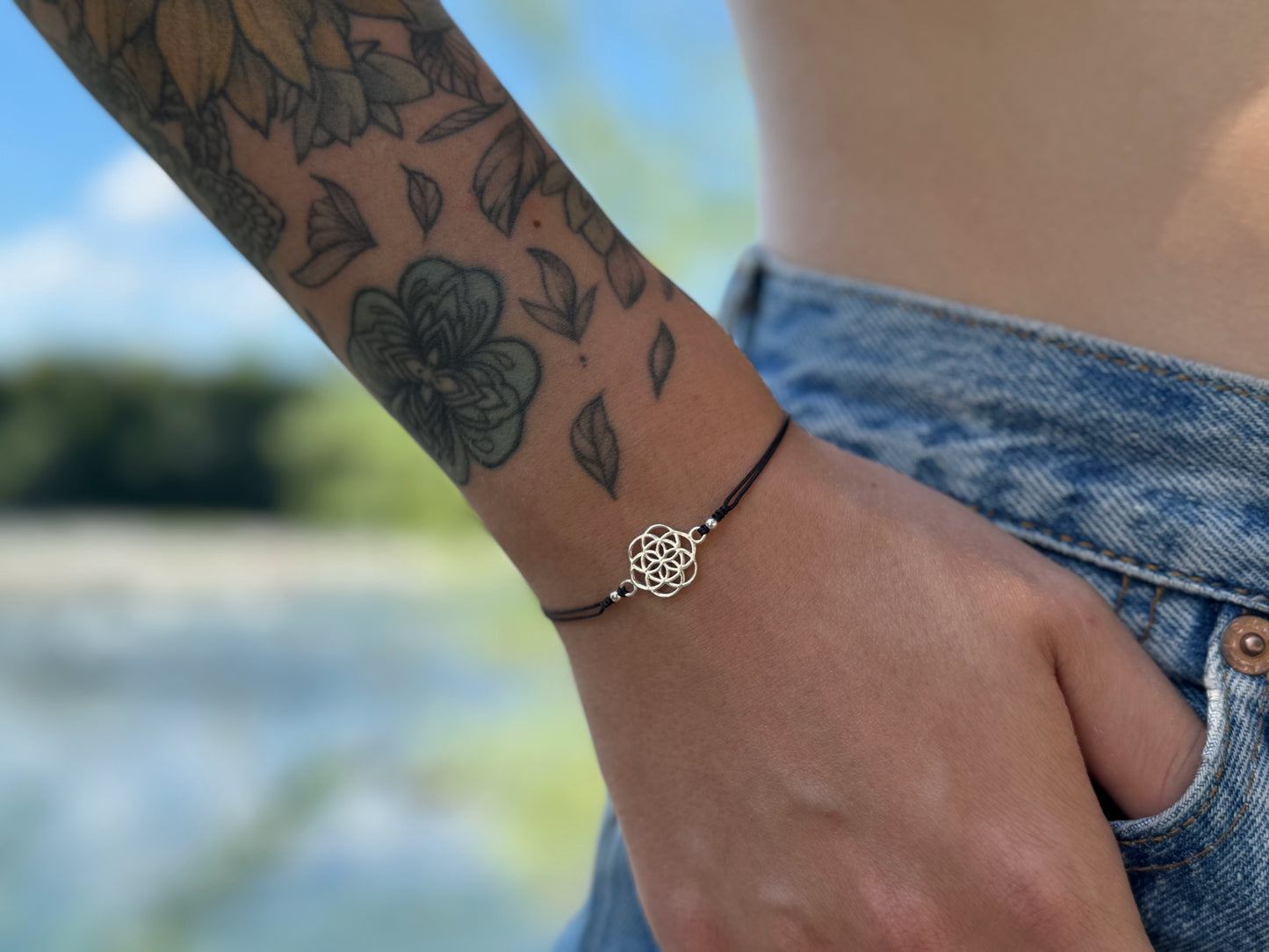 Bracelet made of silver beads with small flowers