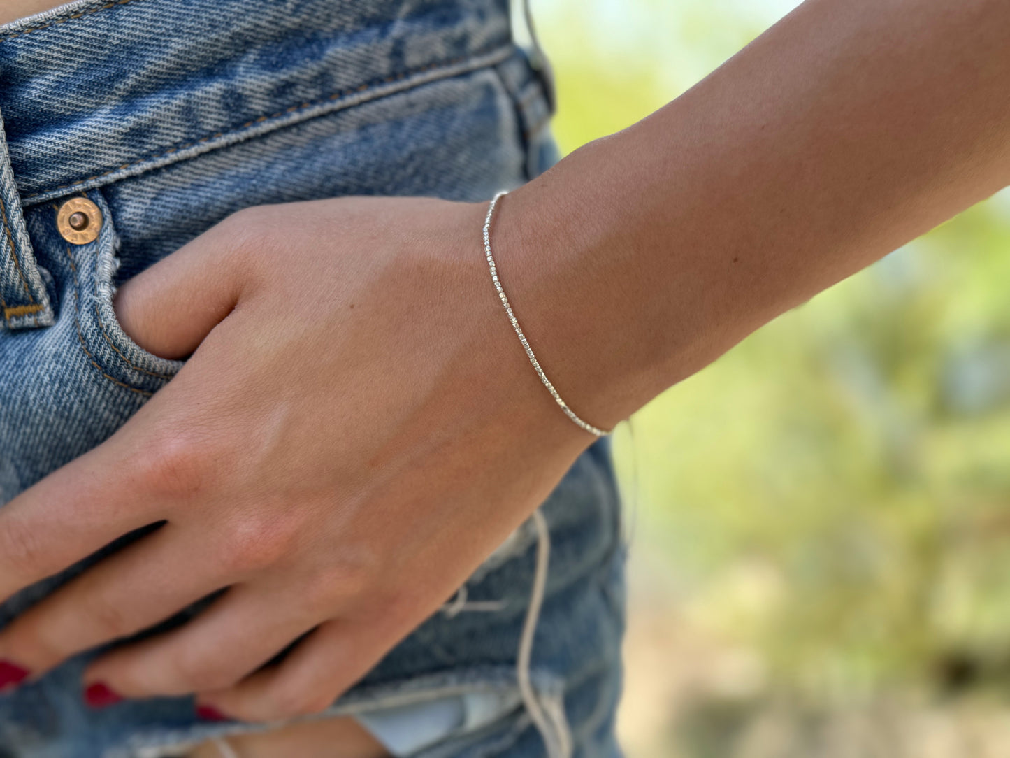 Bracelet made of silver beads with small flowers