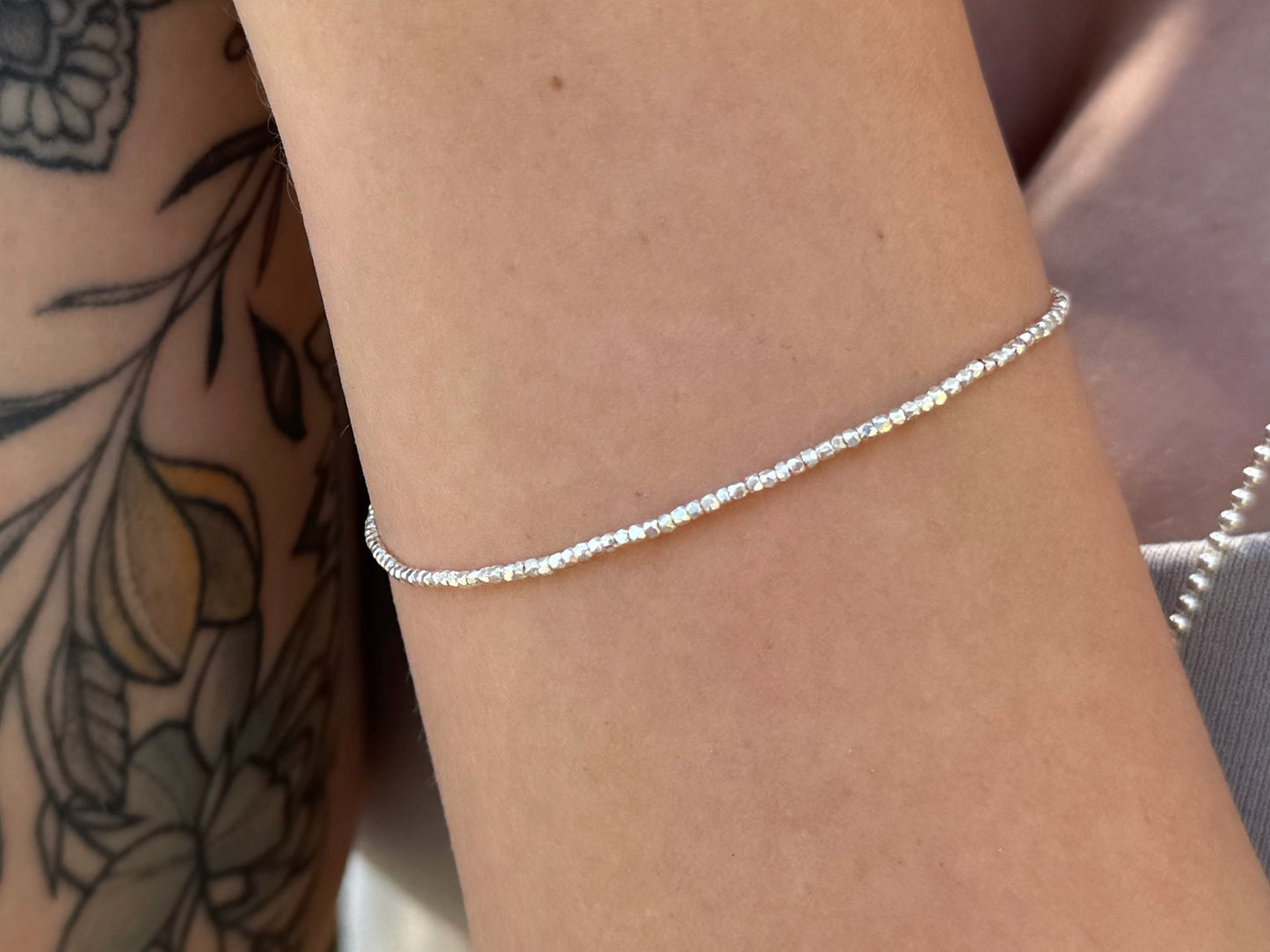Bracelet made of silver beads with small flowers