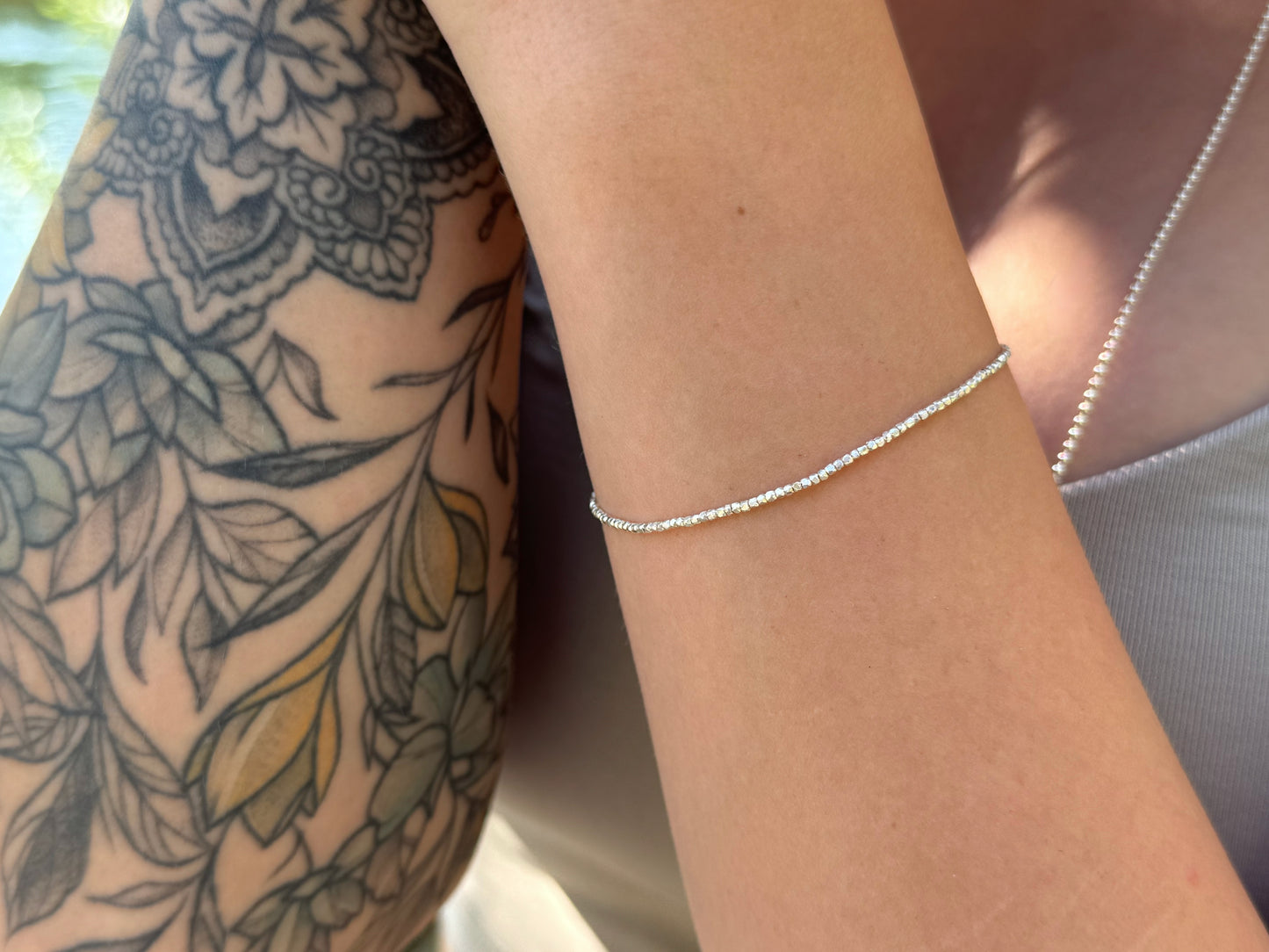 Bracelet made of silver beads with small flowers