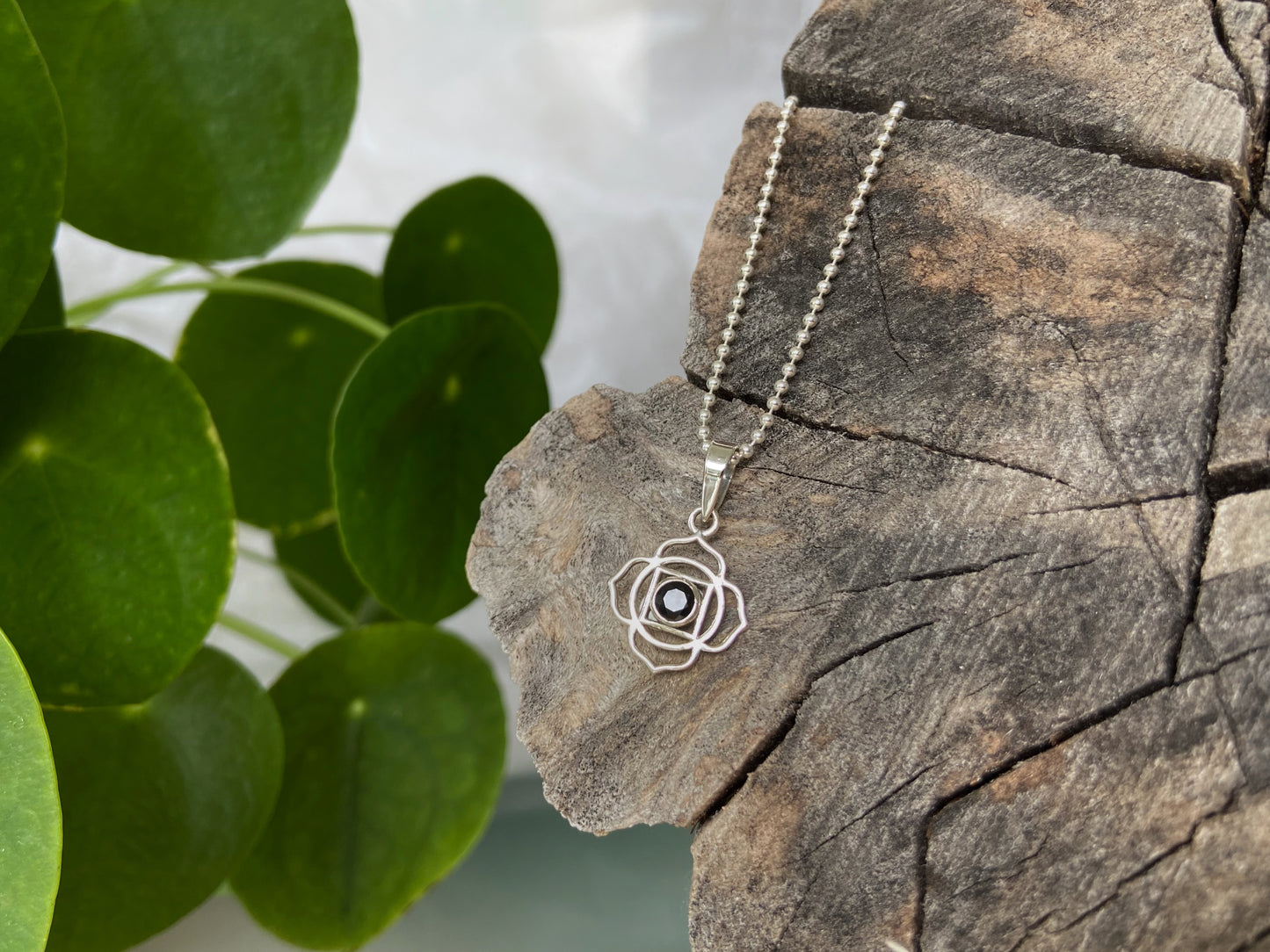 small geometric flower pendant with stone made of silver
