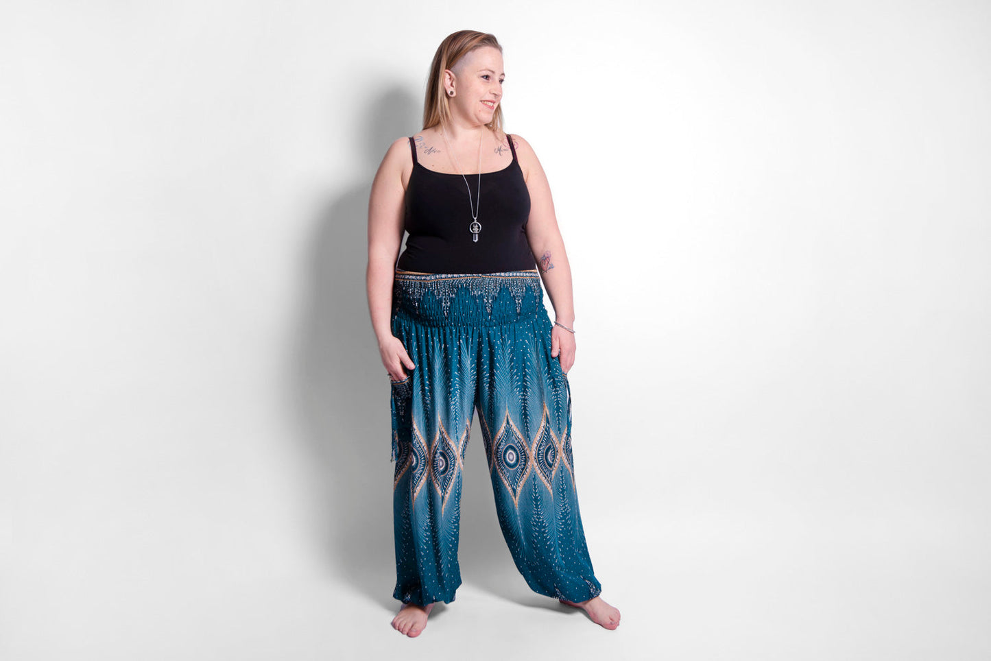 PLUS SIZE harem pants with a peacock pattern in turquoise