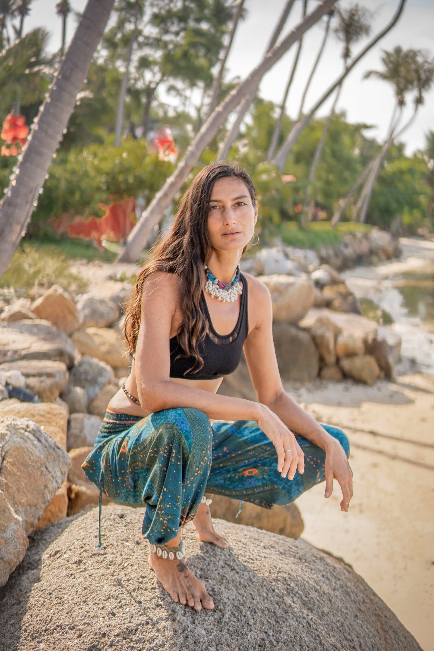 Airy harem pants with a peacock pattern in turquoise