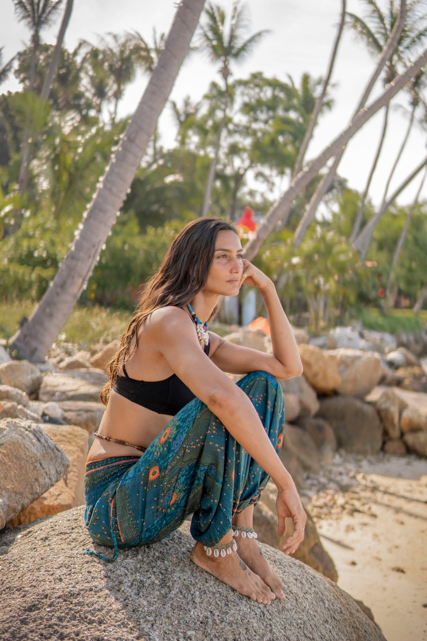 Airy harem pants with a peacock pattern in turquoise
