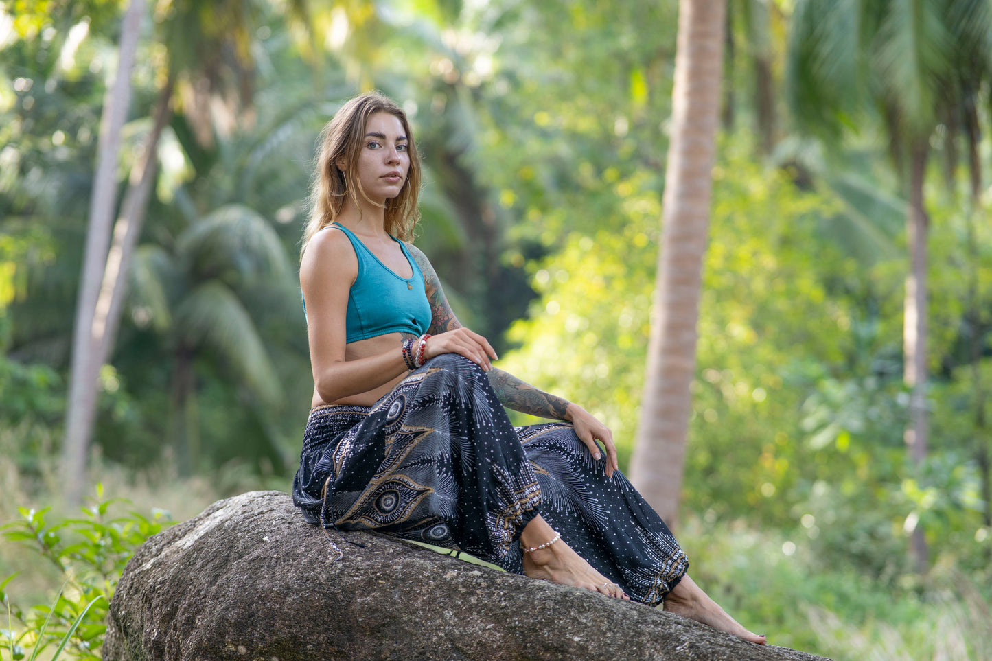 Airy harem pants with a peacock pattern in black