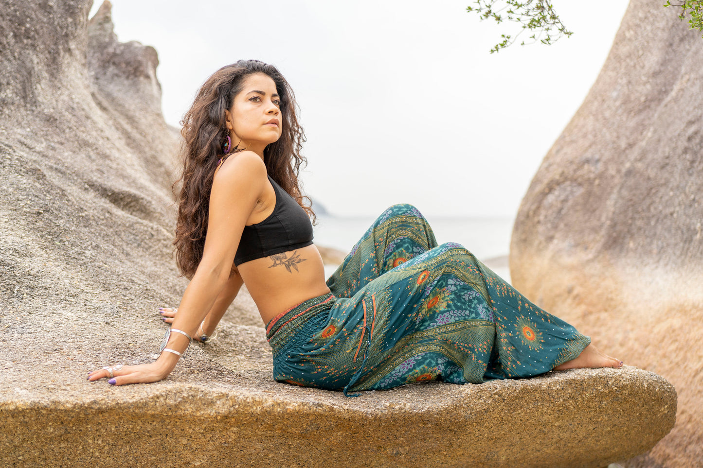 Airy harem pants with a peacock pattern in turquoise