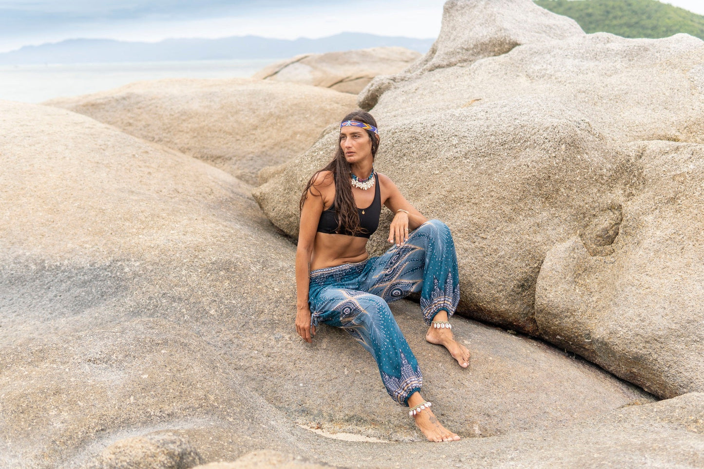 Airy harem pants with a peacock pattern in turquoise