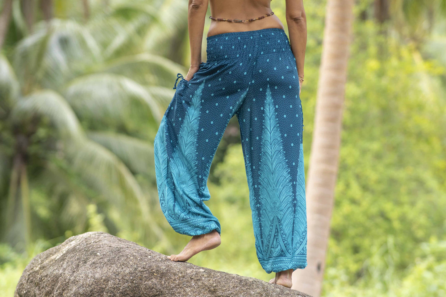 Airy harem pants with a peacock pattern in turquoise with pockets