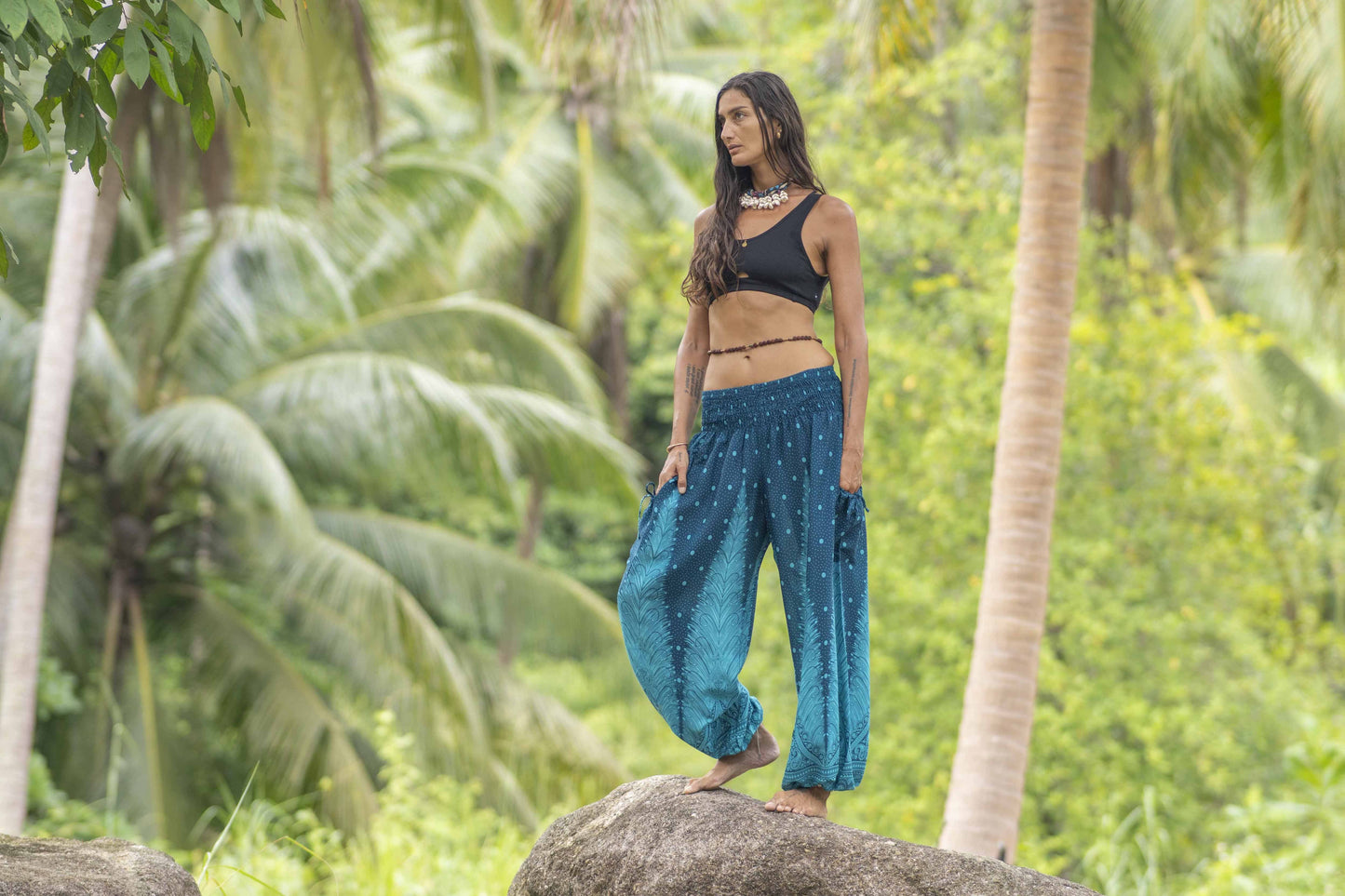 Airy harem pants with a peacock pattern in turquoise with pockets