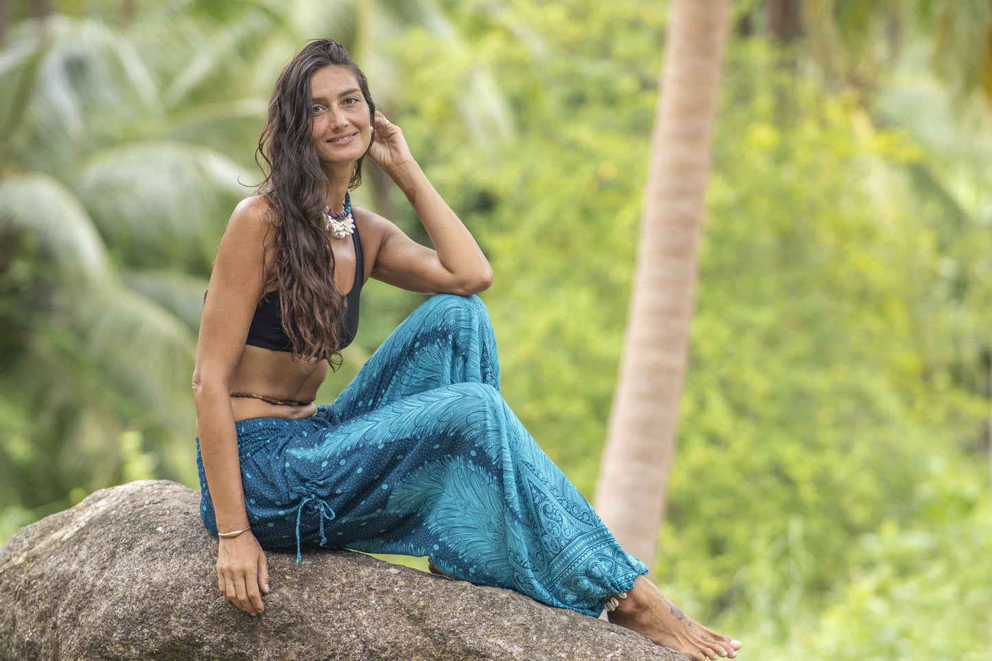 Airy harem pants with a peacock pattern in turquoise with pockets