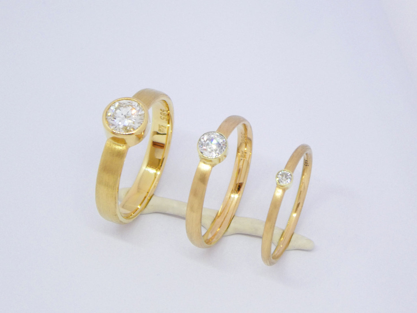 narrow handcrafted gold ring with diamond