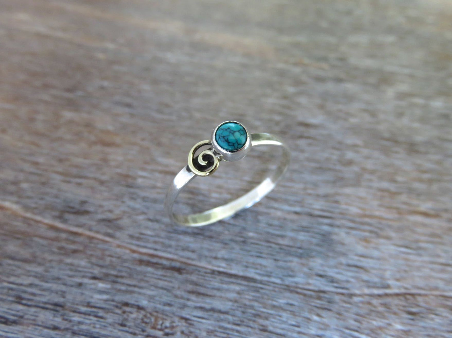 Silver ring with spiral made of brass and turquoise stone