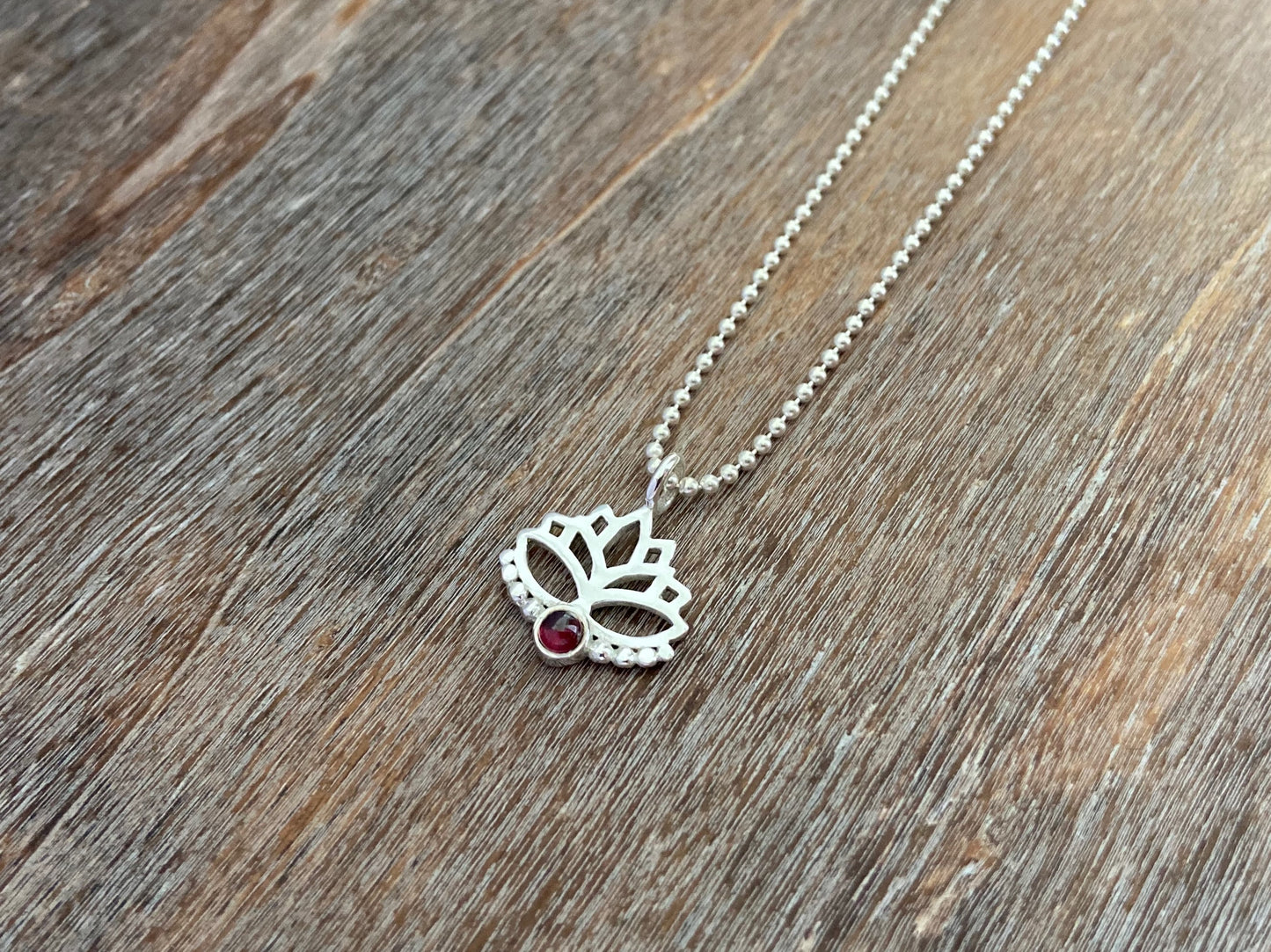 Lotus flower pendant with garnet stone and silver dots