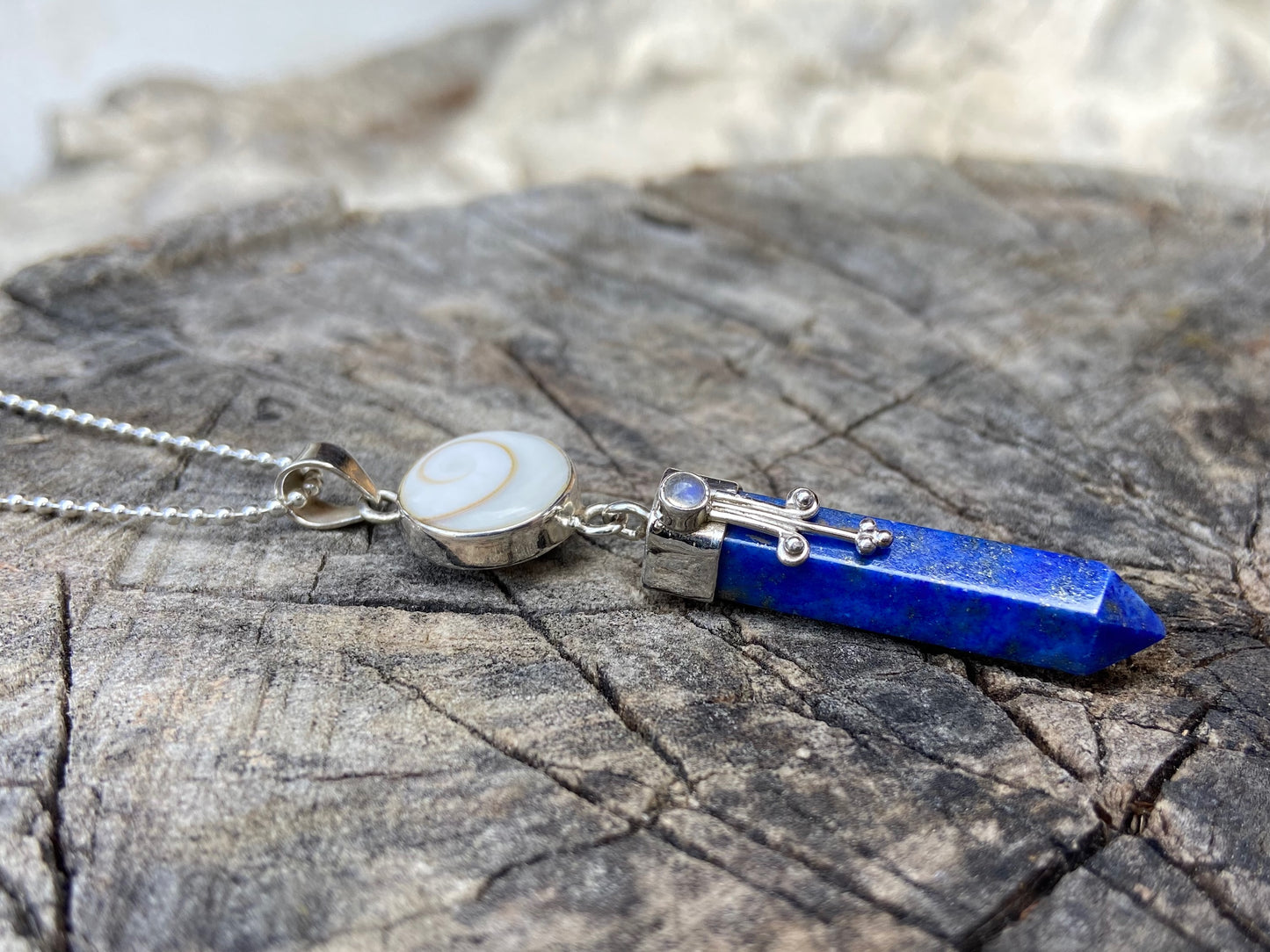Lapis Lazuli pendant with operculum with spirals, dots and small stone, silver