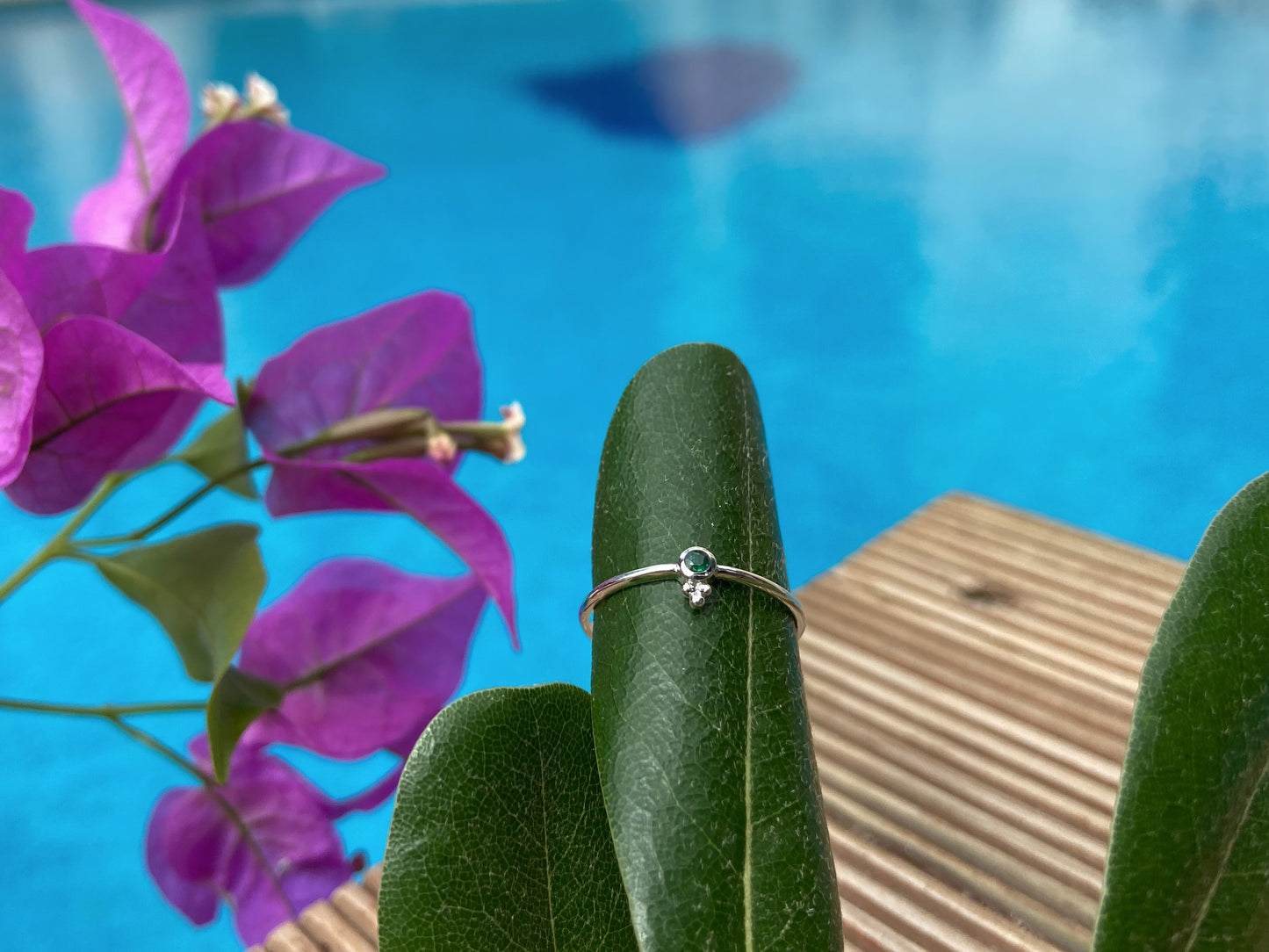 Dainty silver ring with a small faceted green emerald stone and three beads