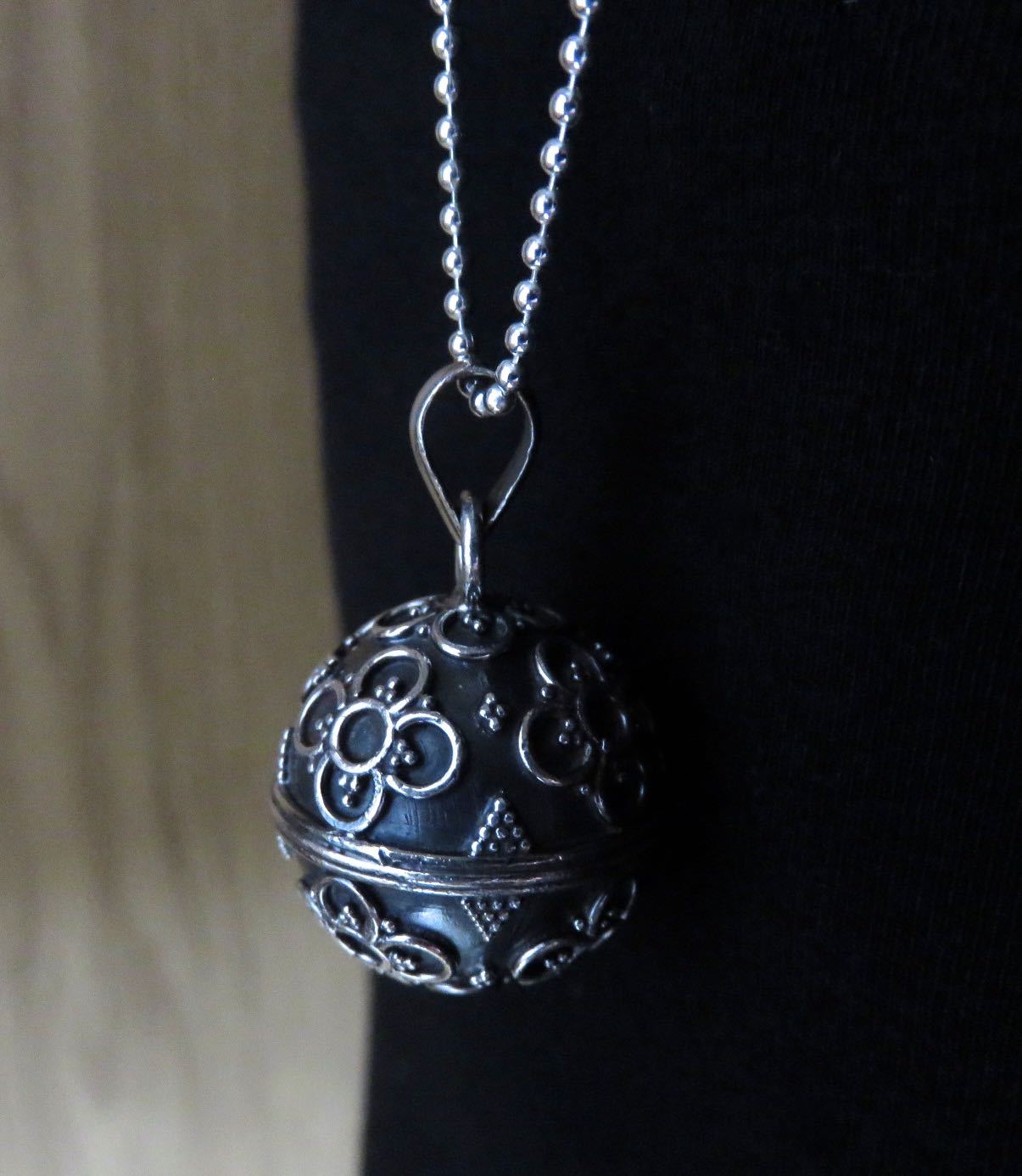 Silver sound ball decorated with flowers and beads