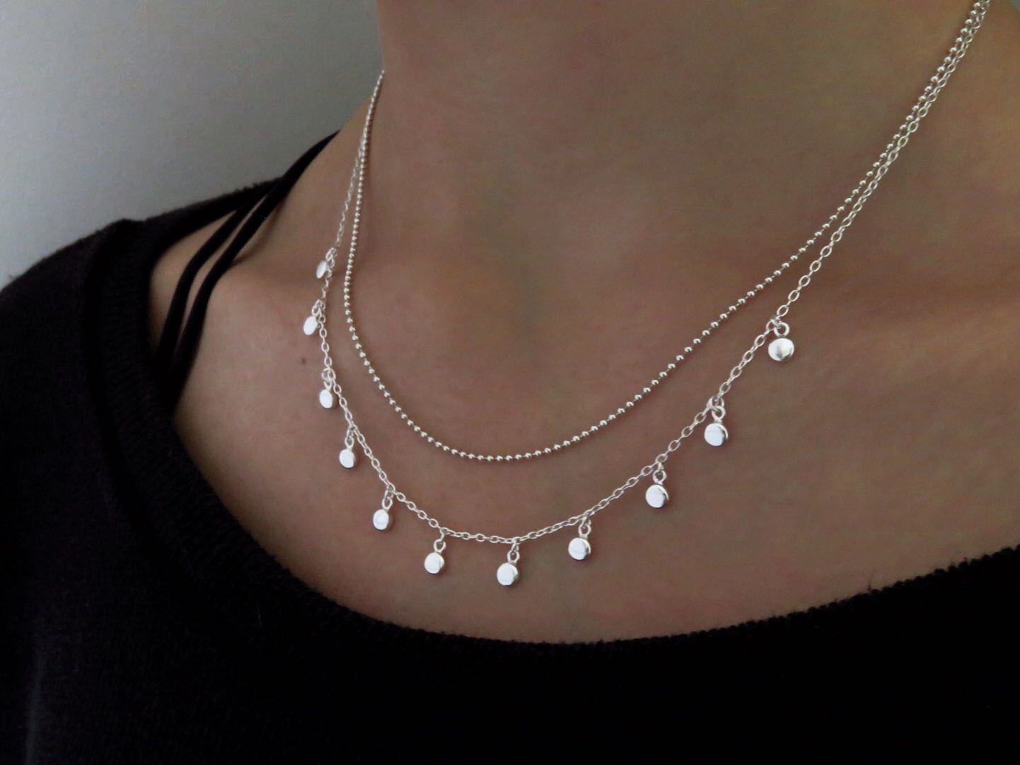 Necklace with small dangling round silver pendants