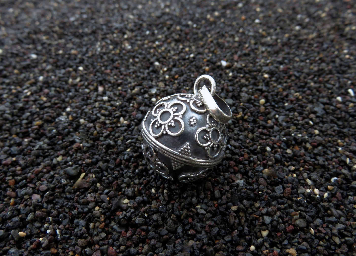 Silver sound ball decorated with flowers and beads