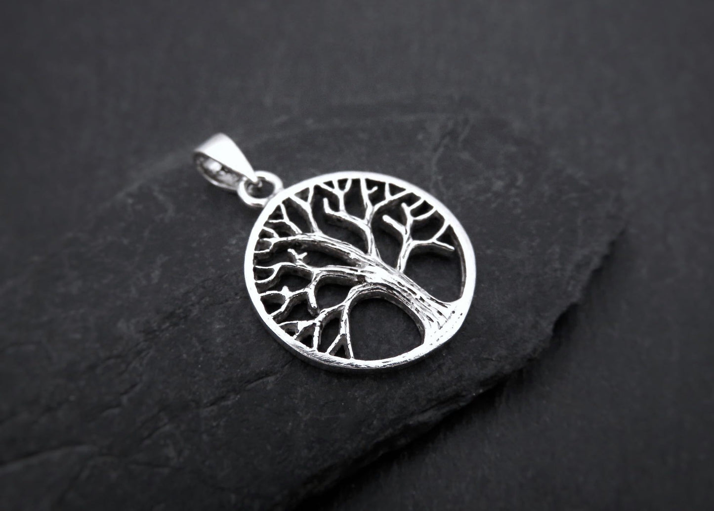 small pendant with the tree of life motif made of silver
