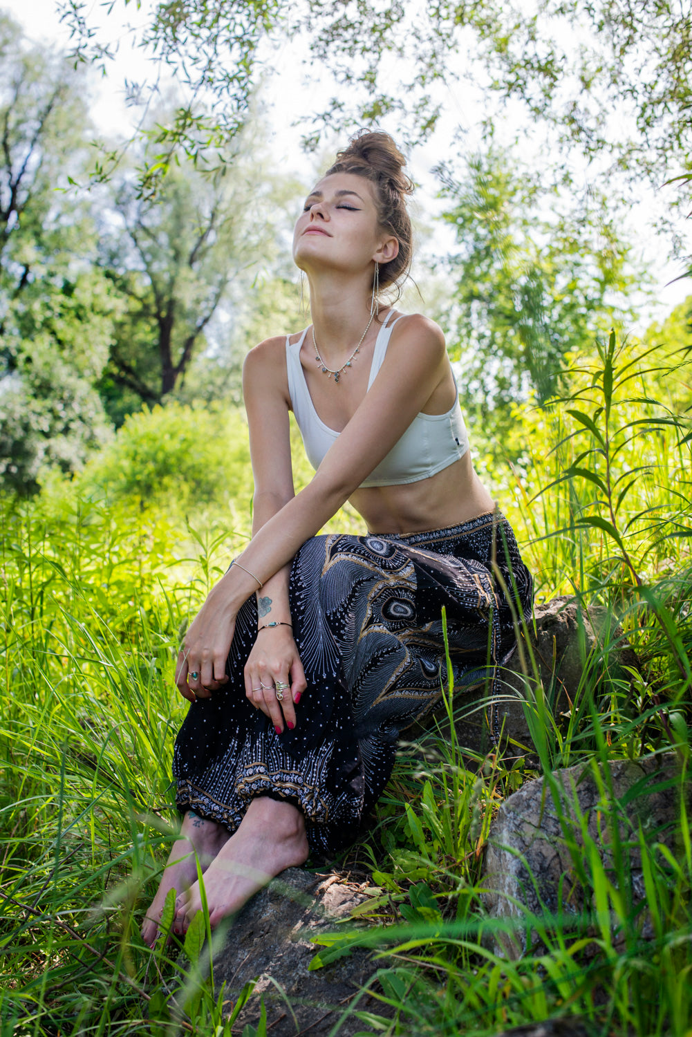 Airy harem pants with a peacock pattern in black