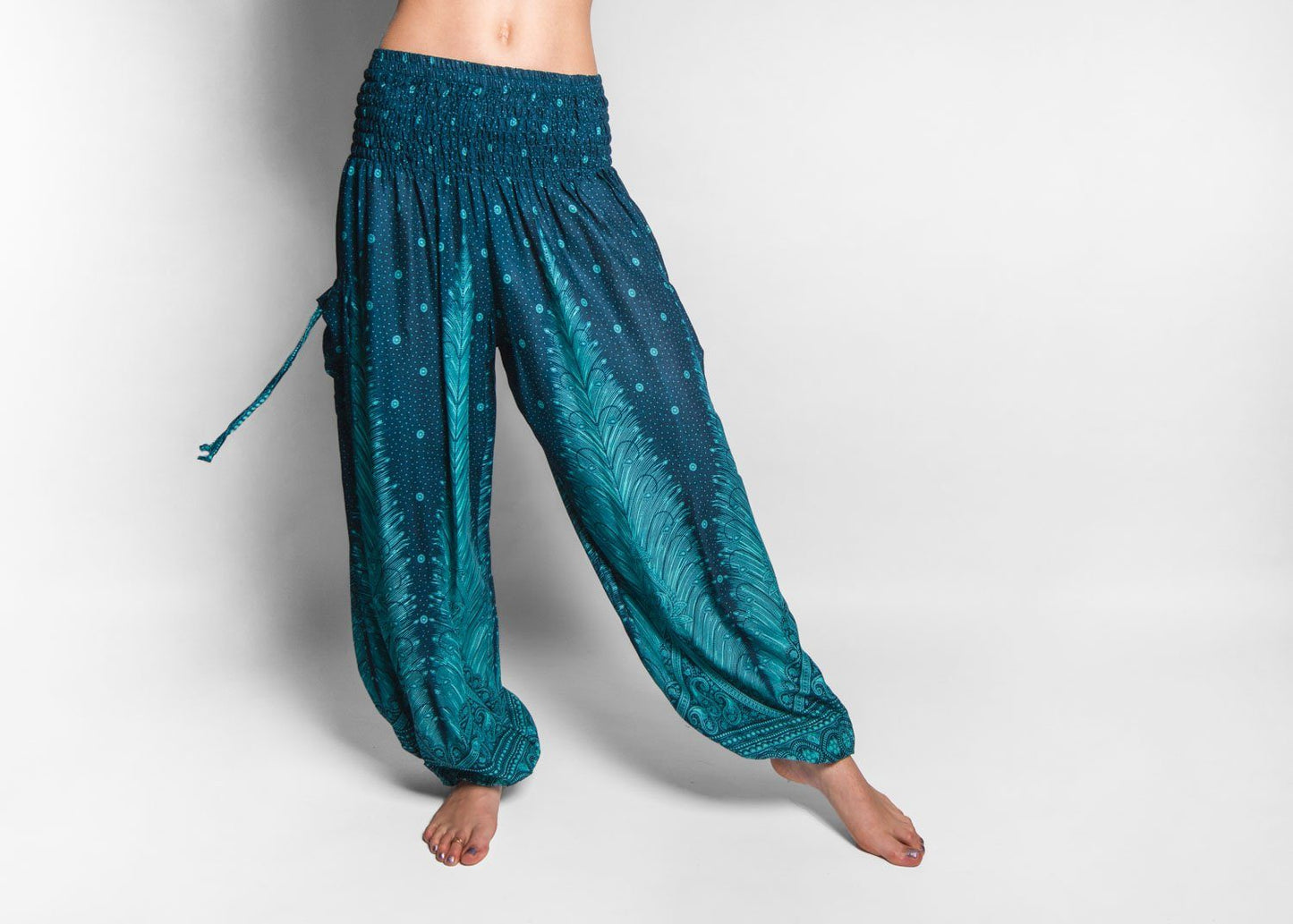 Airy harem pants with a peacock pattern in turquoise with pockets
