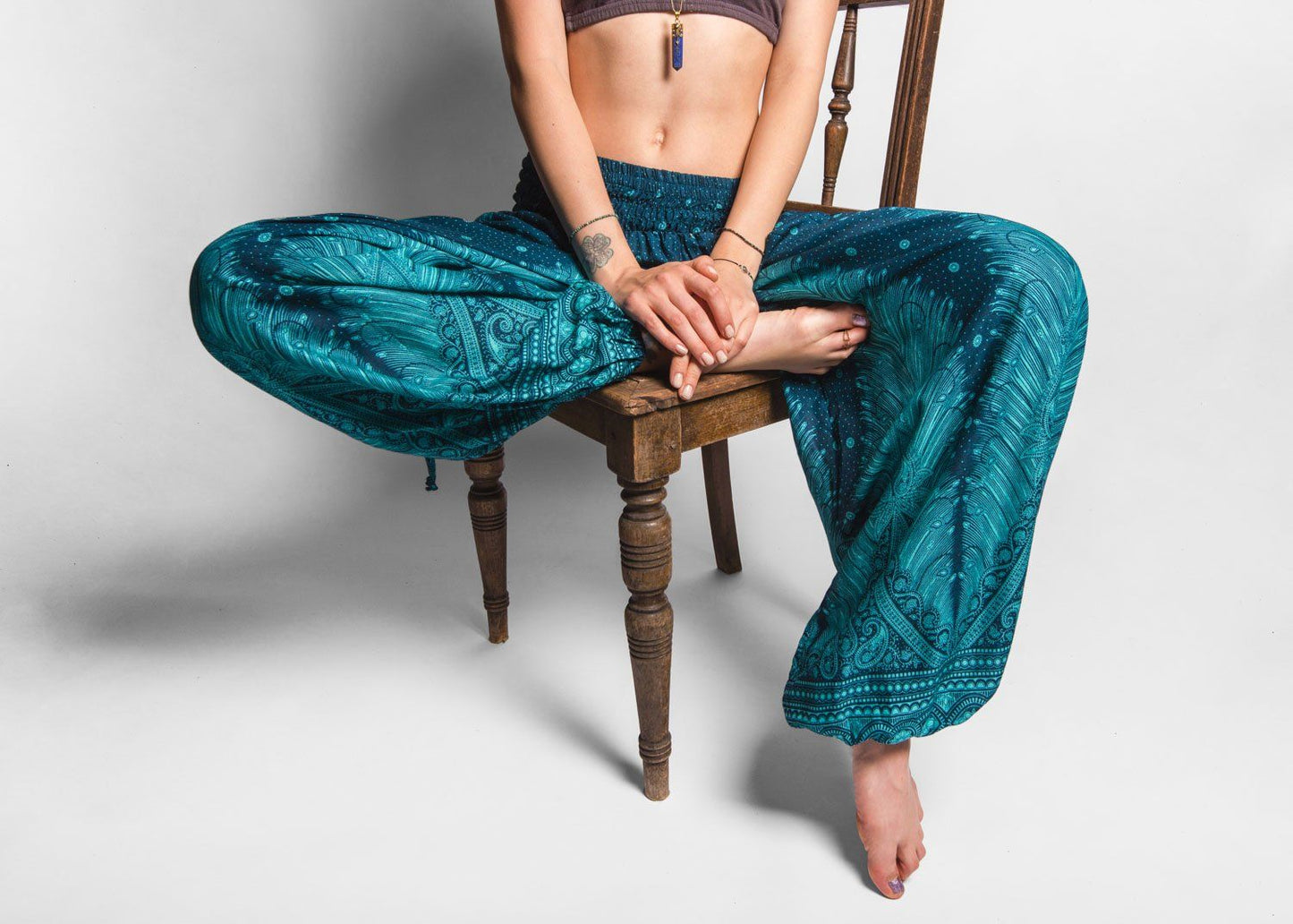 Airy harem pants with a peacock pattern in turquoise with pockets