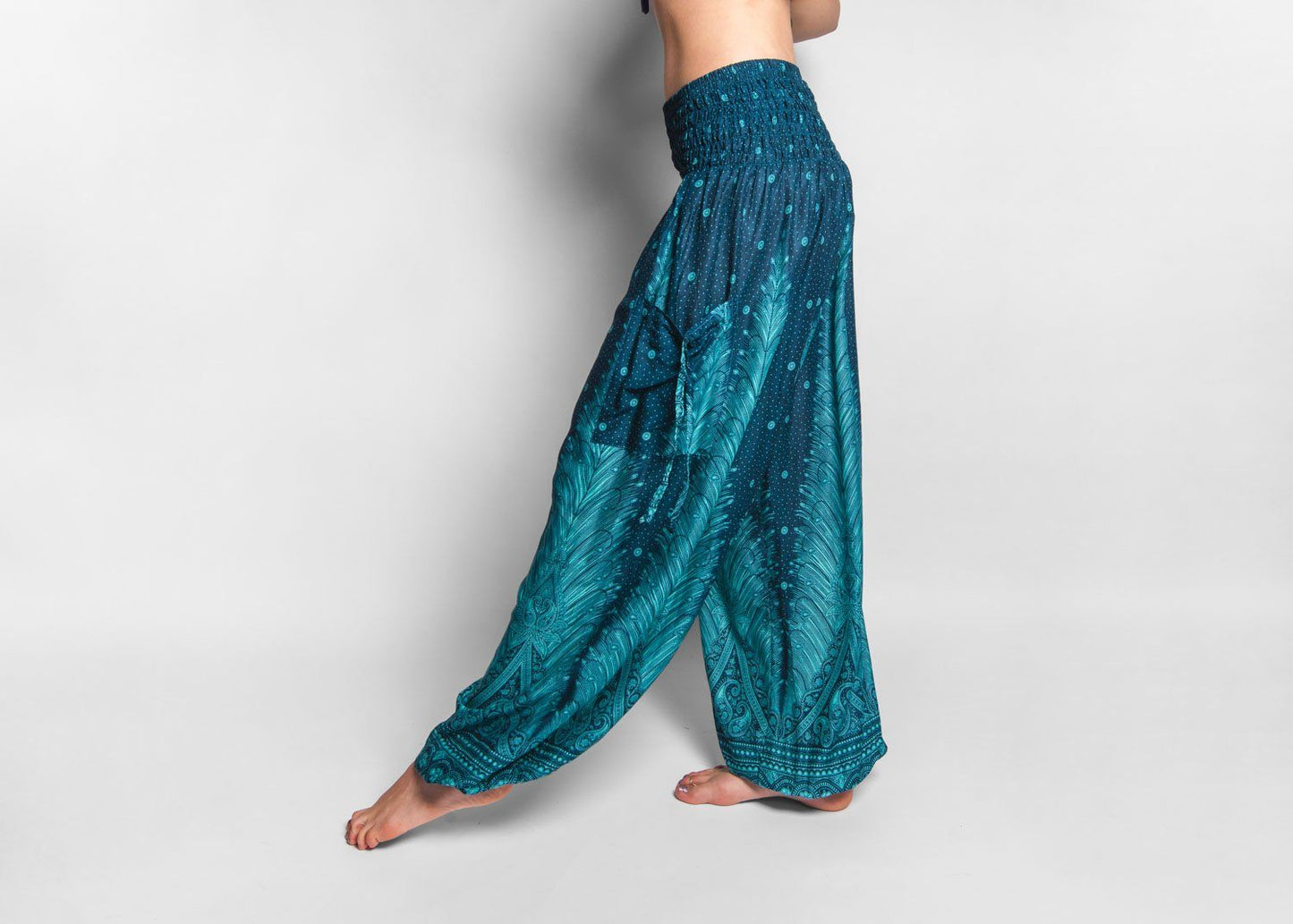 Airy harem pants with a peacock pattern in turquoise with pockets