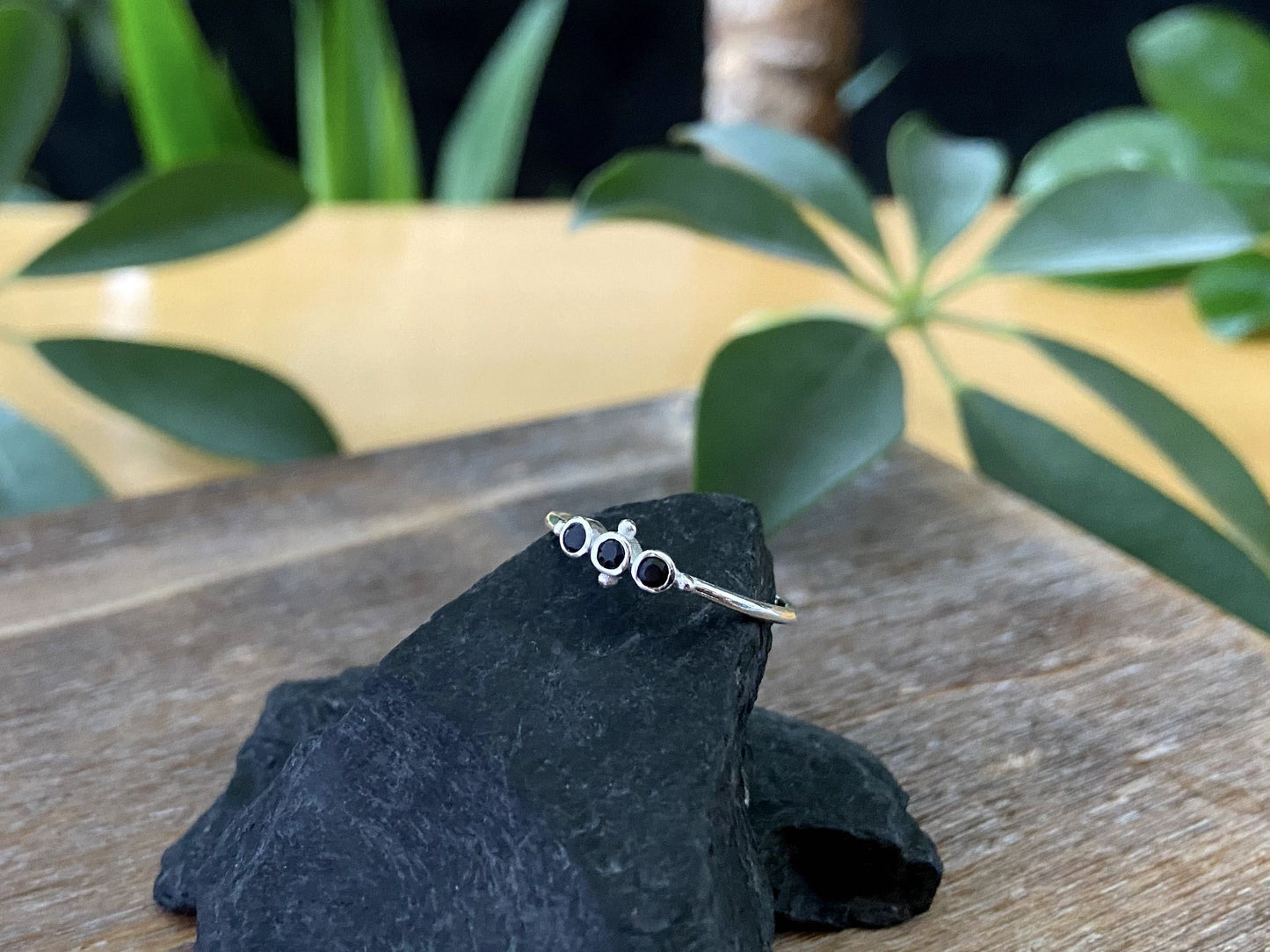 Ring with three small black faceted stones made of silver