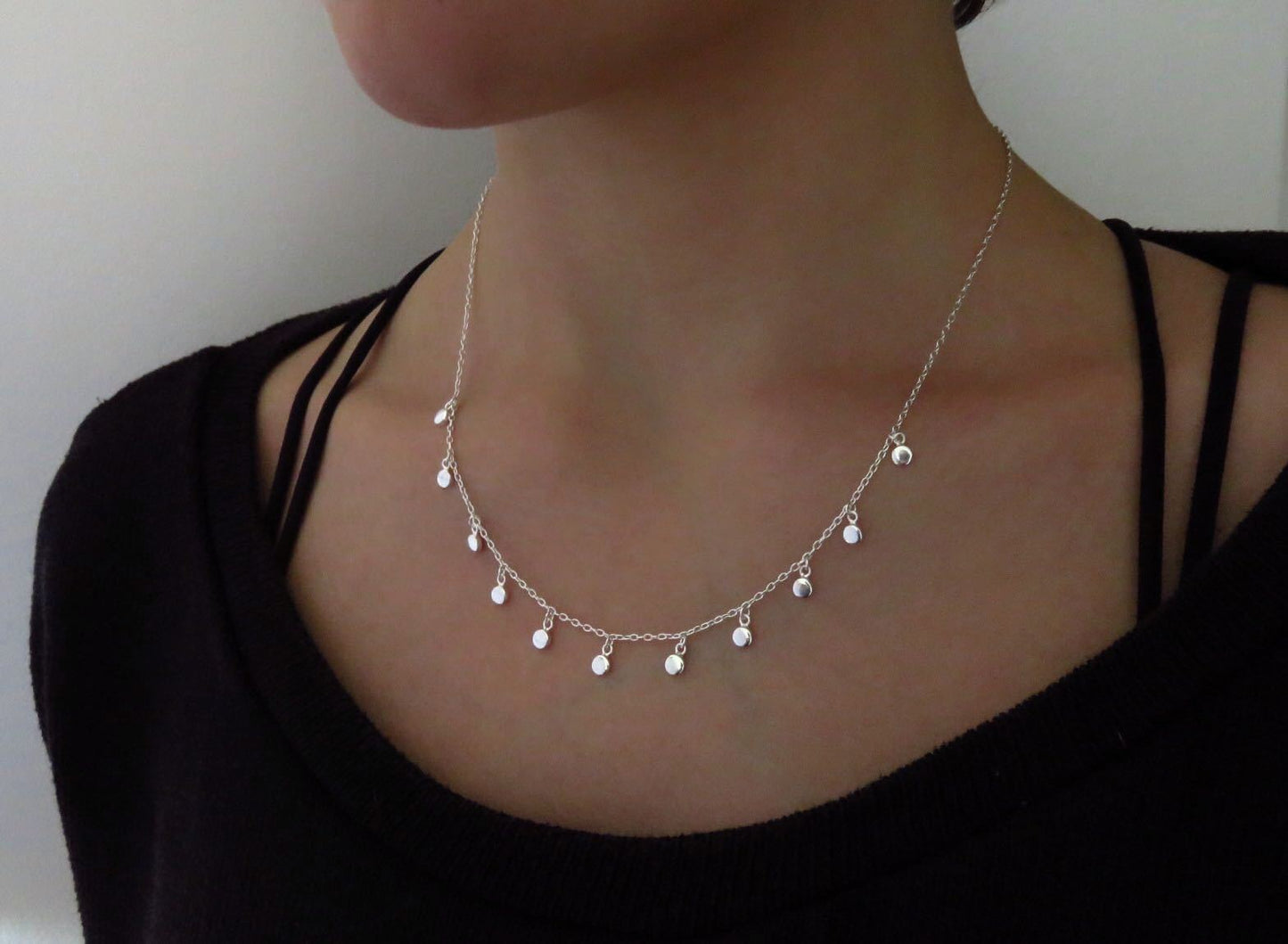 Necklace with small dangling round silver pendants