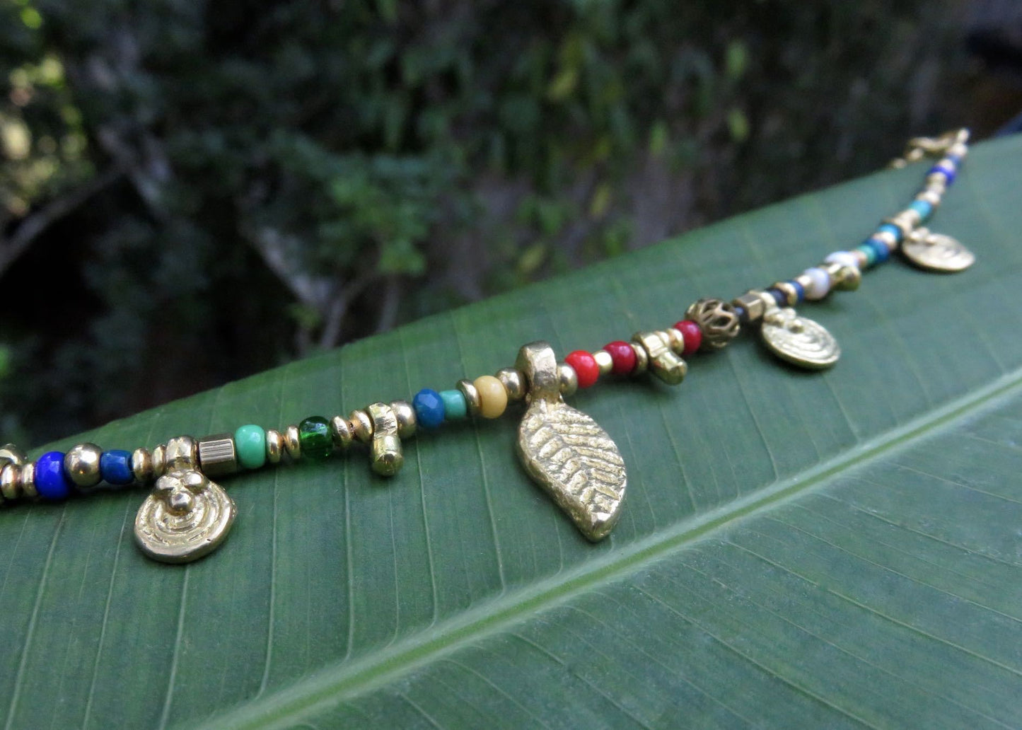 colorful bracelet with small pendants and brass beads