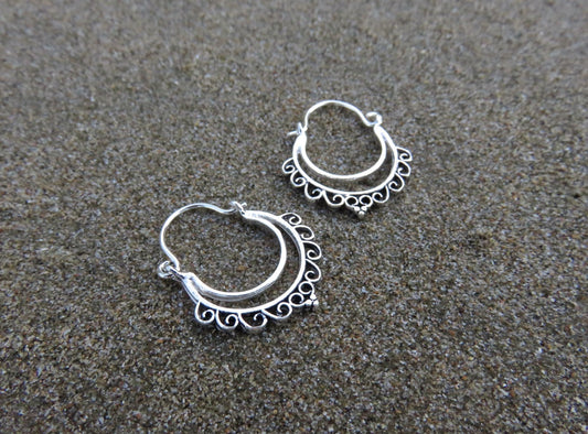small hoop earrings with a filigree spiral pattern made of silver