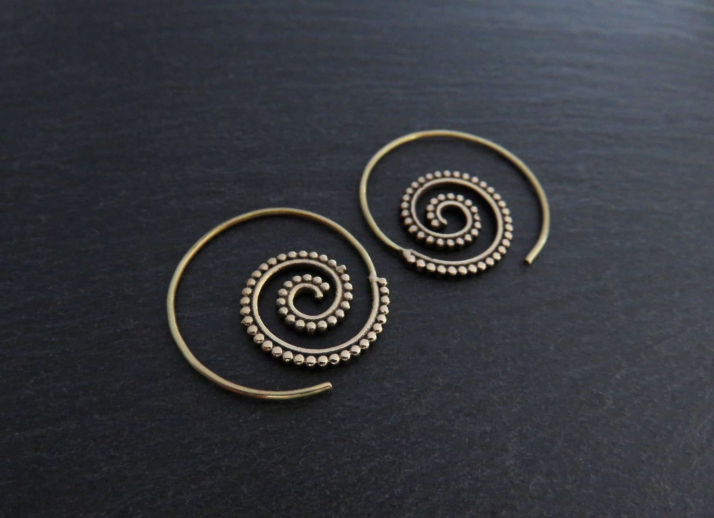 small spiral earrings with dot pattern made of brass