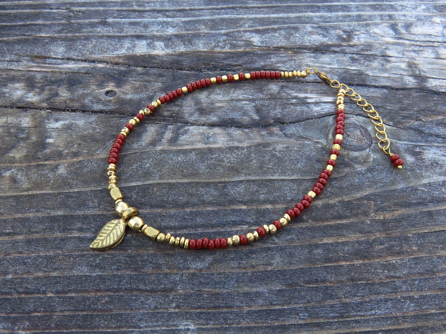Anklet with small brass leaf and colored beads