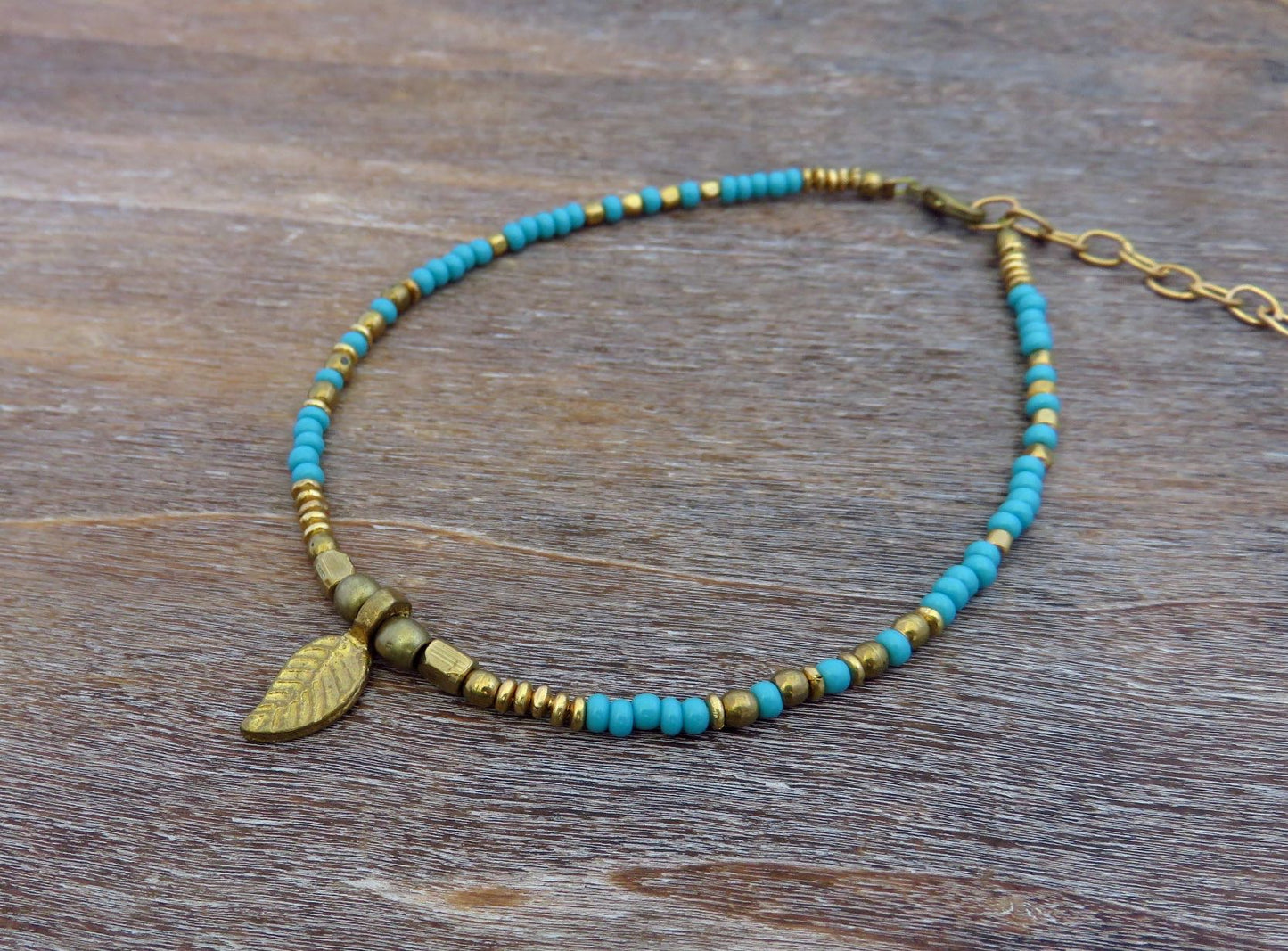 Anklet with small brass leaf and colored beads