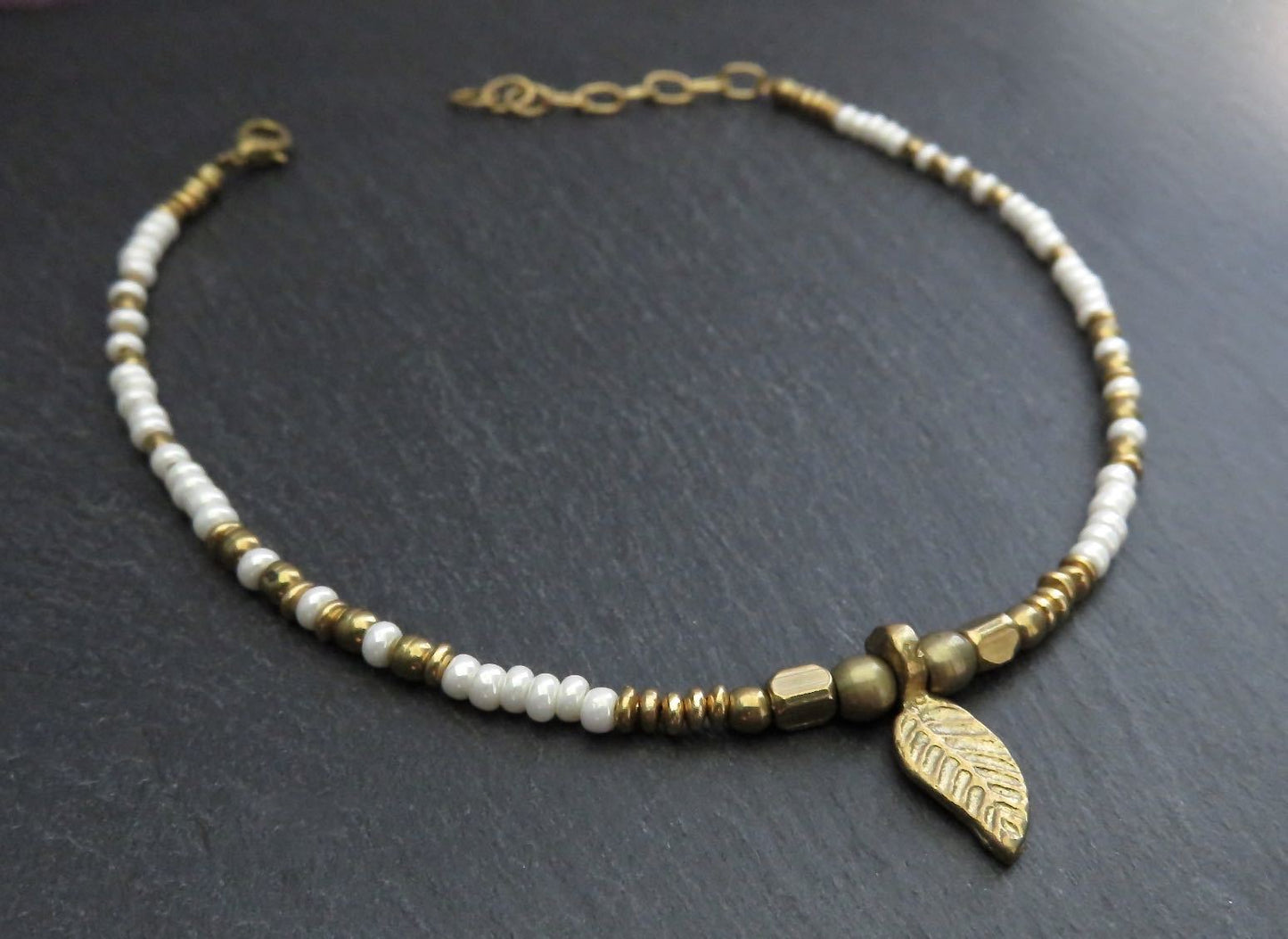 Anklet with small brass leaf and colored beads