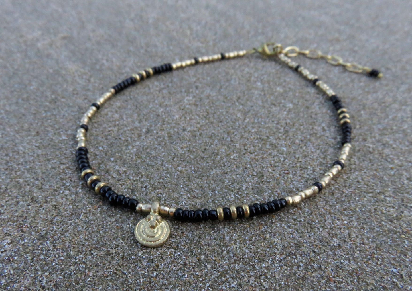 Anklet with a small spiral pendant made of brass