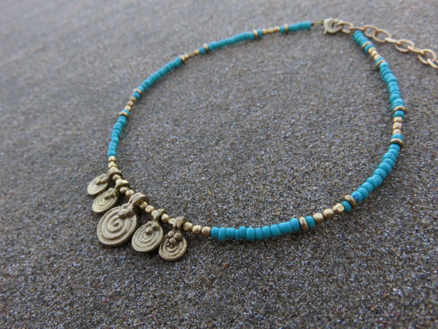 Anklet with small spiral pendants made of brass