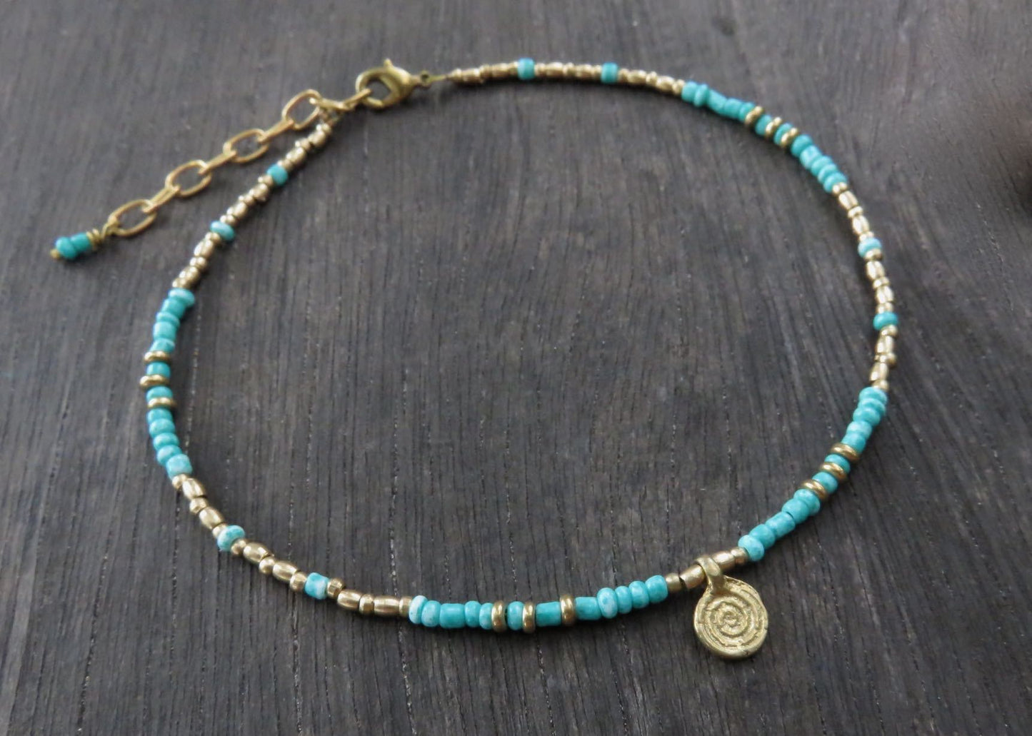 Anklet with a small spiral pendant made of brass