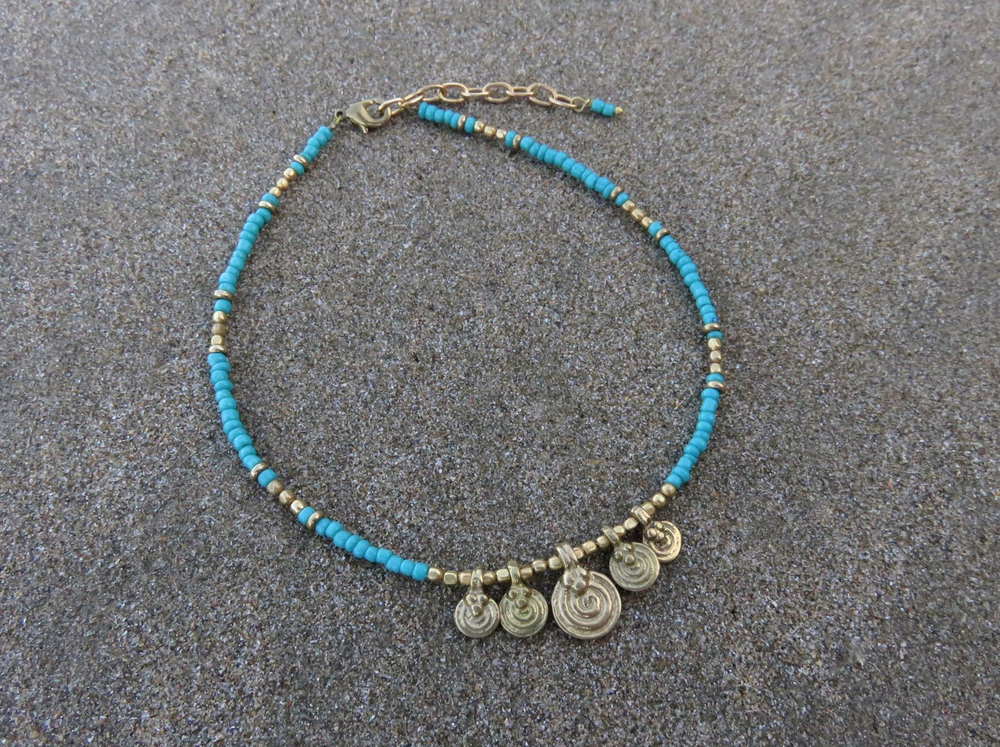 Anklet with small spiral pendants made of brass
