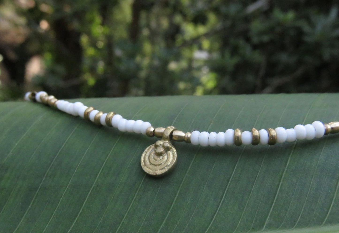 Anklet with a small spiral pendant made of brass