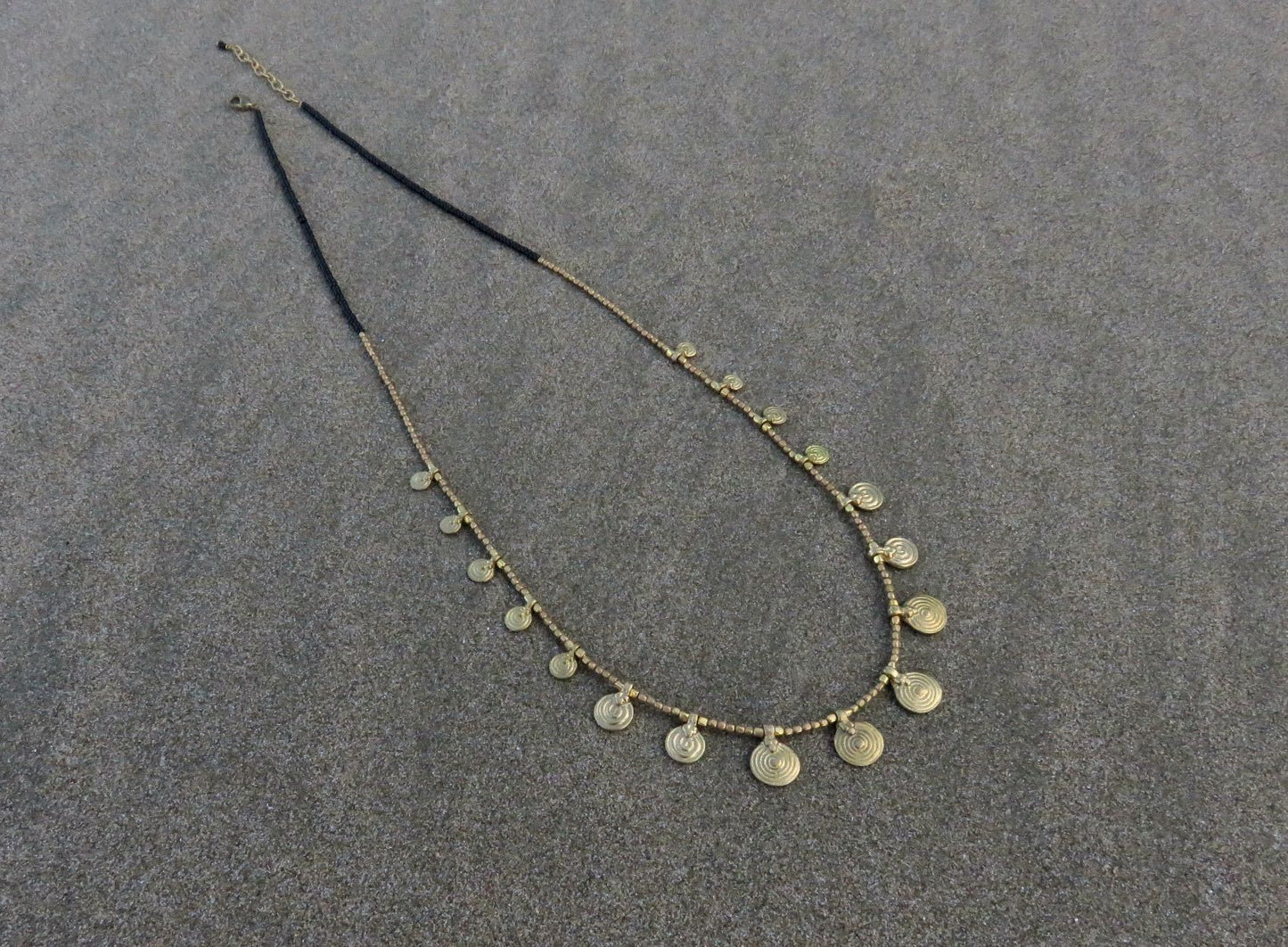 long necklace with brass spirals and black beads