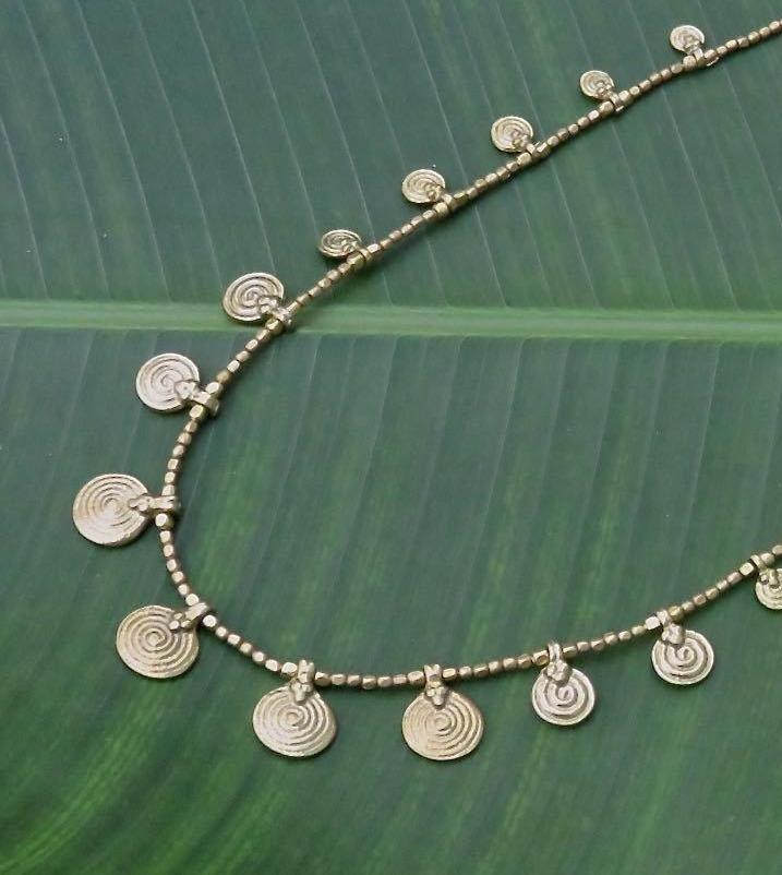 long necklace with brass spirals and black beads