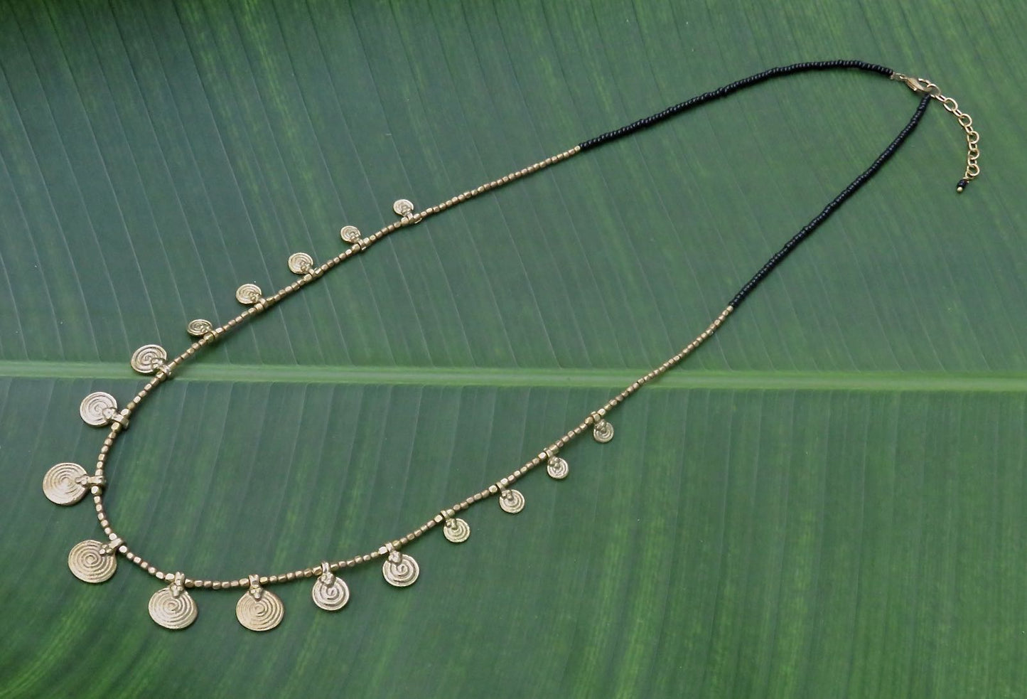 long necklace with brass spirals and black beads