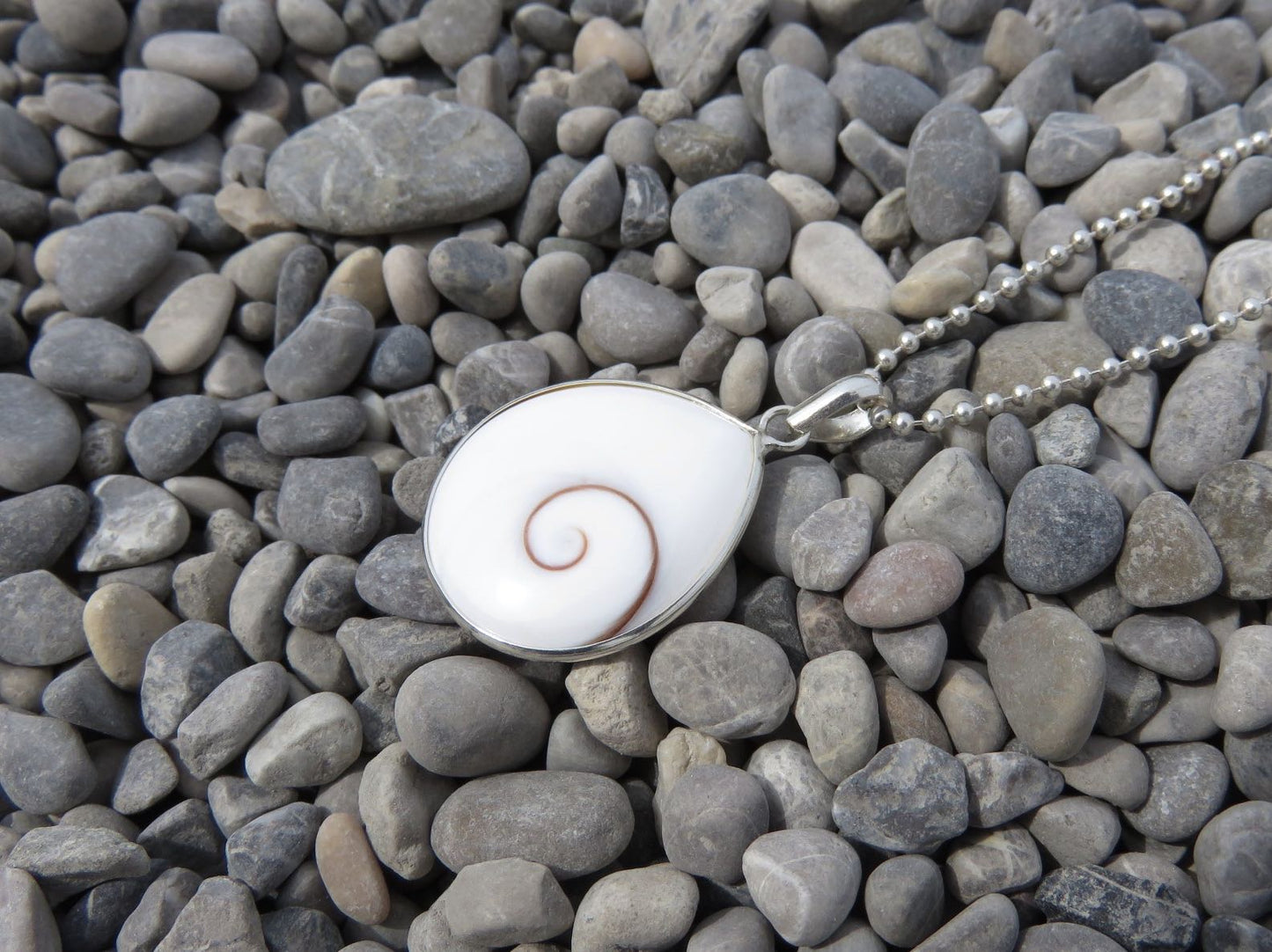 teardrop-shaped operculum pendant made of silver