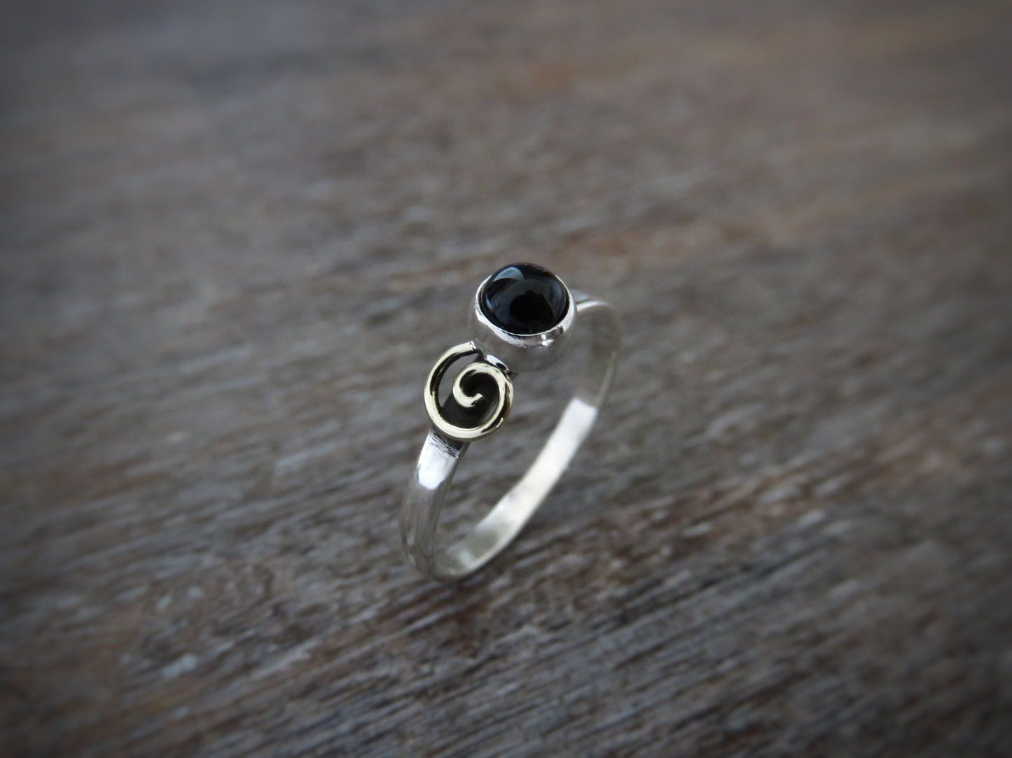Silver ring with spiral made of brass and black stone