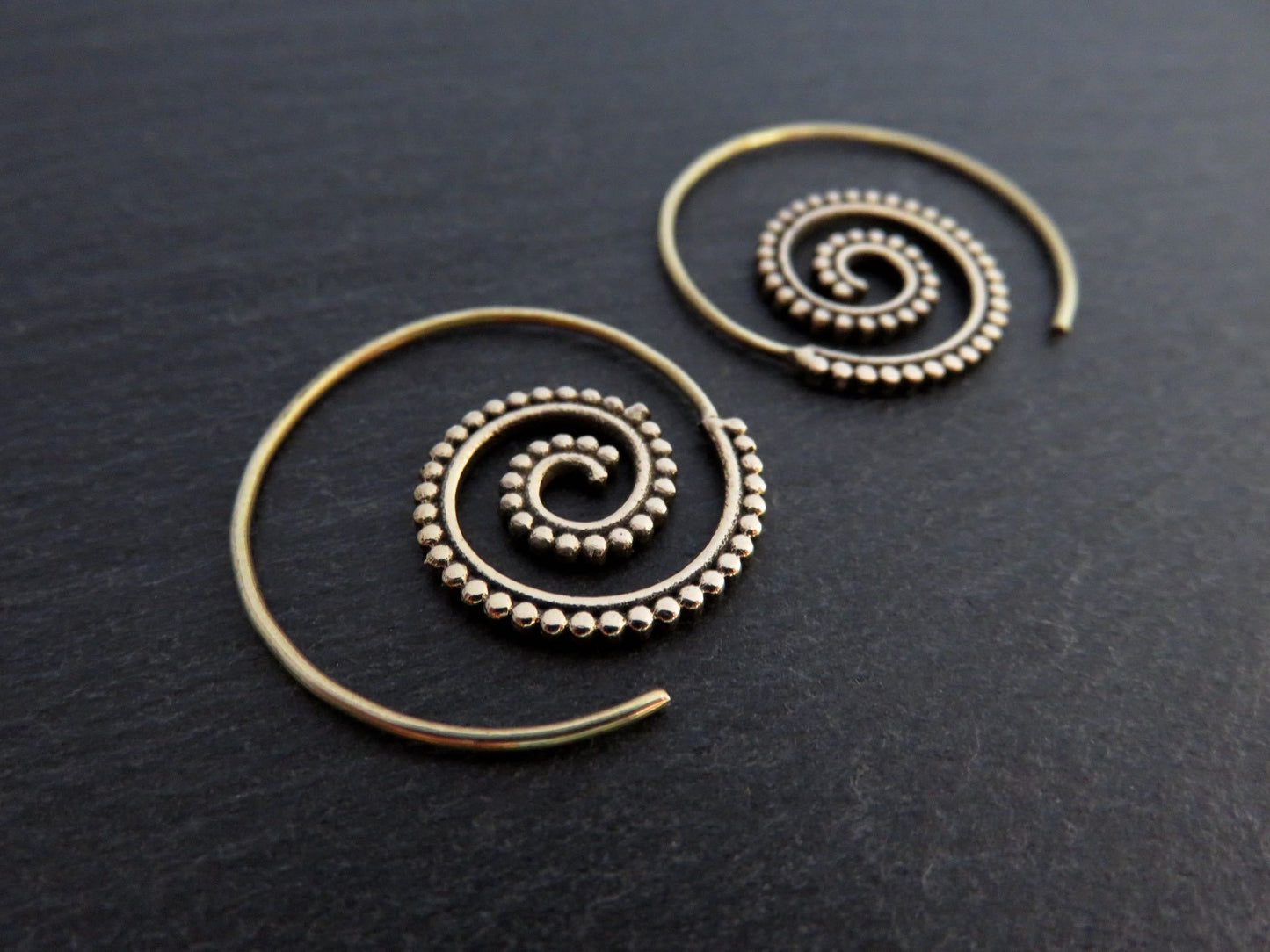 small spiral earrings with dot pattern made of brass
