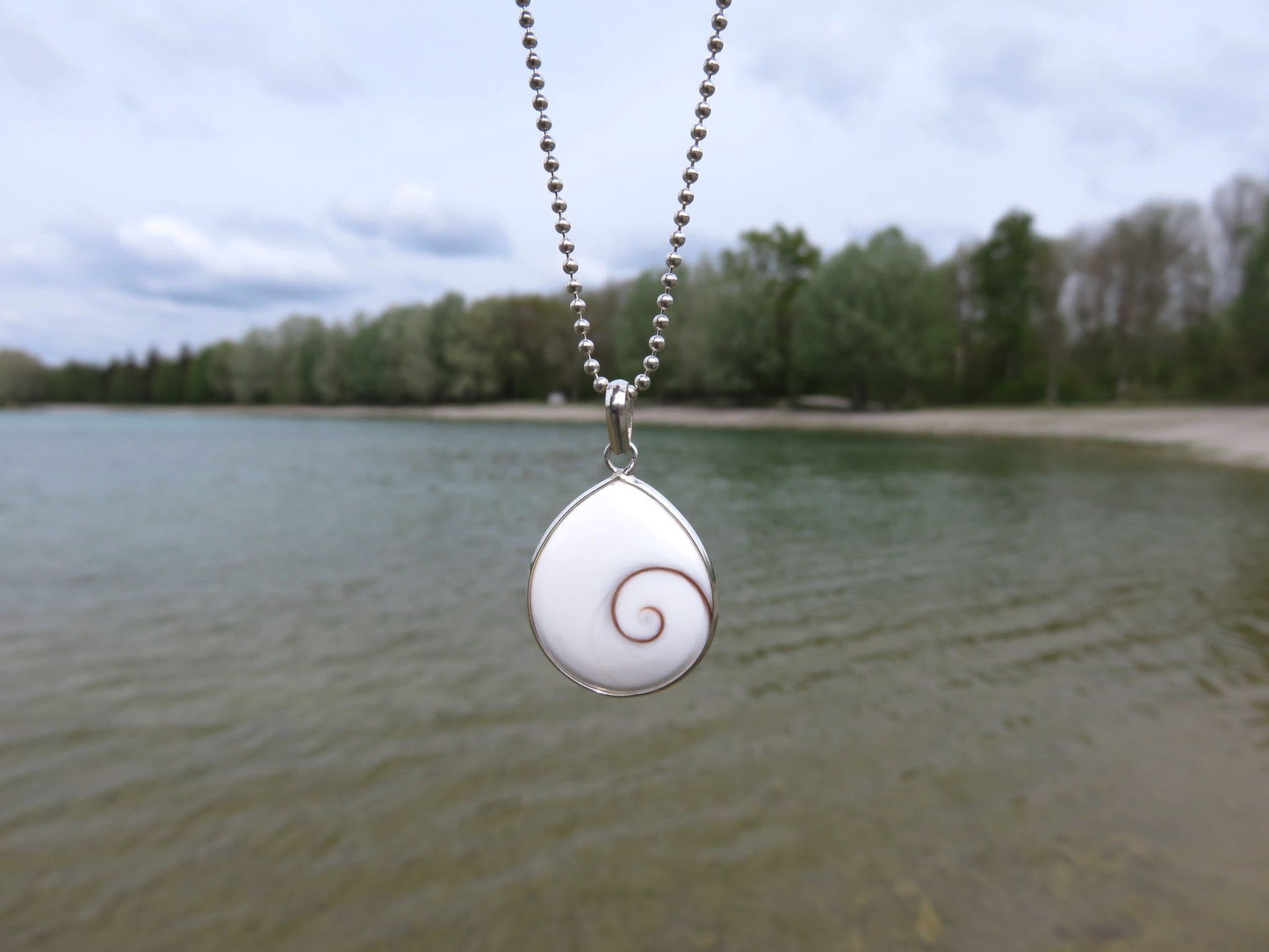 teardrop-shaped operculum pendant made of silver