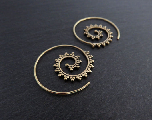 small spiral earrings patterned with small dots made of brass