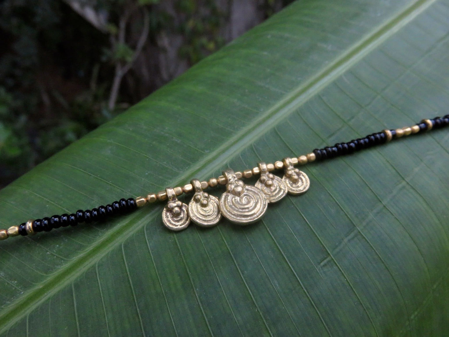 Anklet with small spiral pendants made of brass