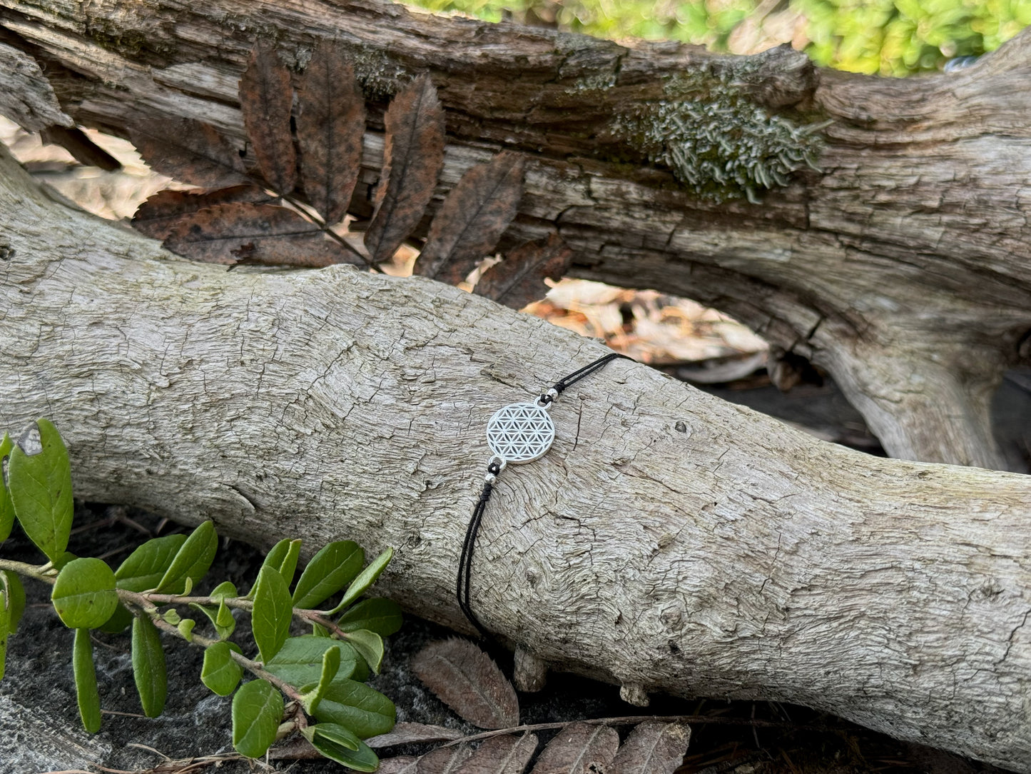 Bracelet made of silver beads with small flowers 